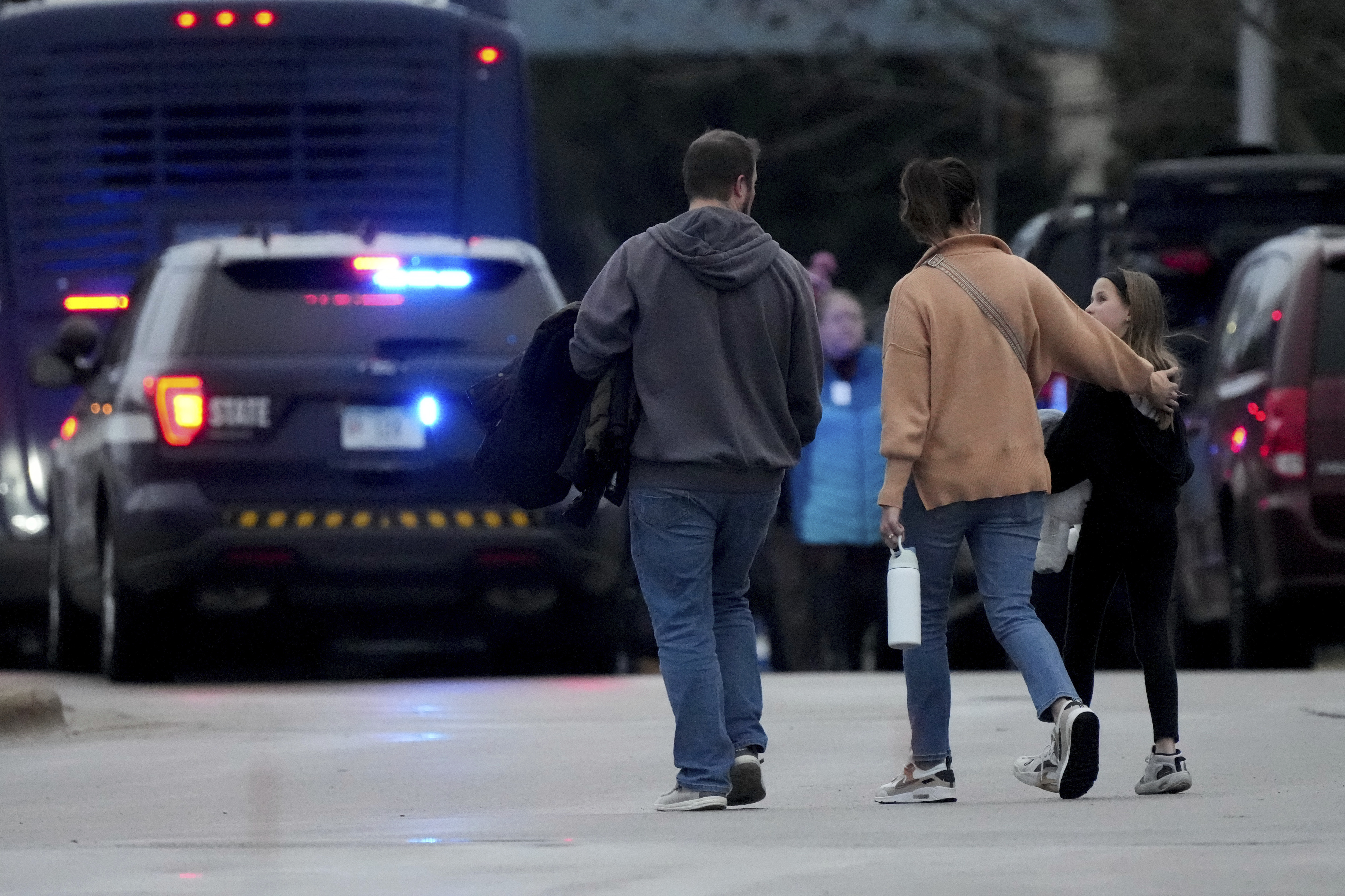 Families leave the SSMI Health Center, set up as a reunification center, following a shooting, Monday, Dec. 16, 2024 in Madison, Wis. (AP Photo/Morry Gash)