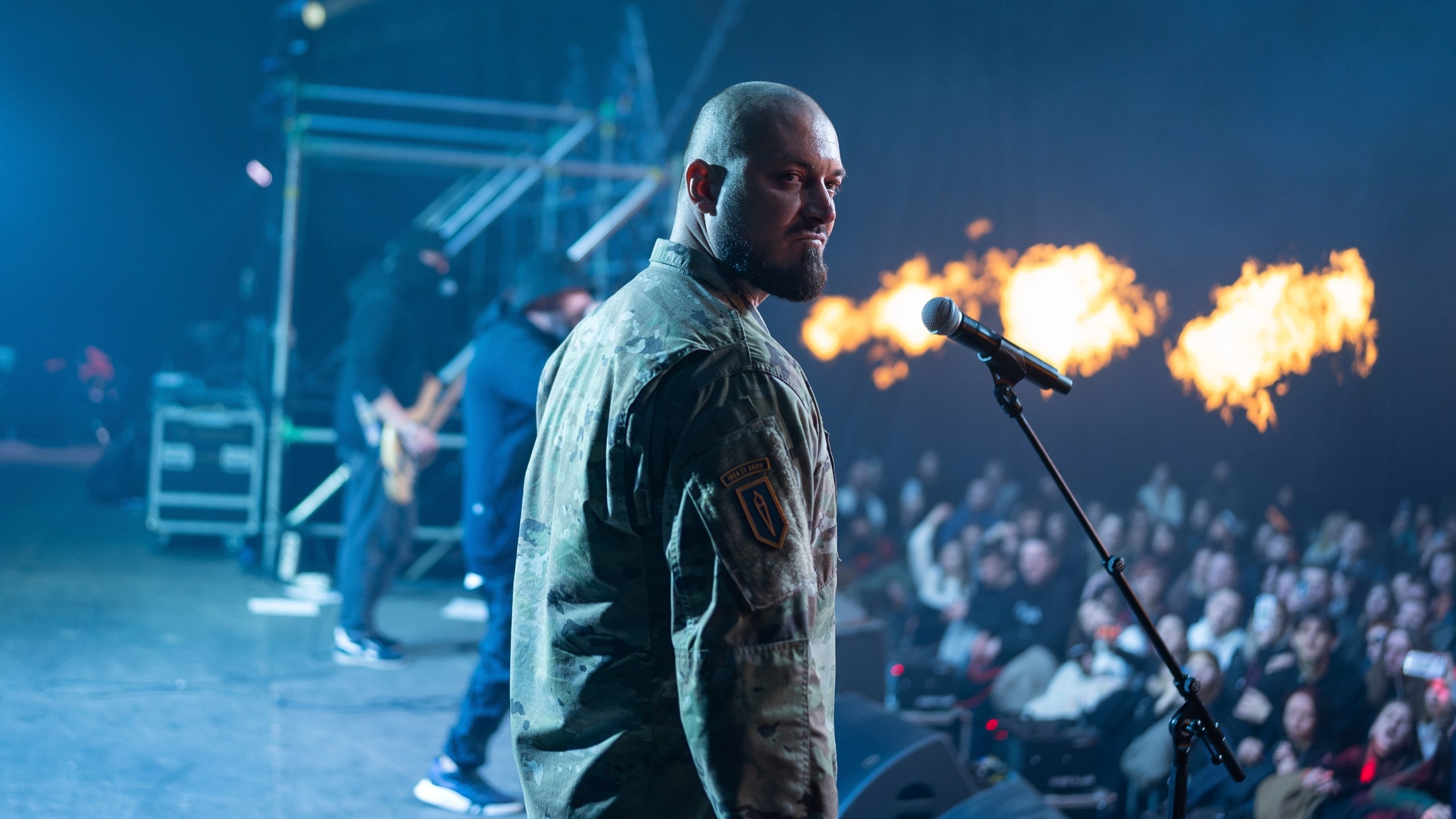 Ukrainian serviceman of 3rd Assault Brigade known by call sign "Avdei" performs together with rock band Proroky, during the presentation of the music album Epoch, a collaboration between Ukrainian artists and the 3rd Assault Brigade, in Kyiv, Ukraine, Saturday, Dec. 7, 2024. (AP Photo/Alex Babenko)