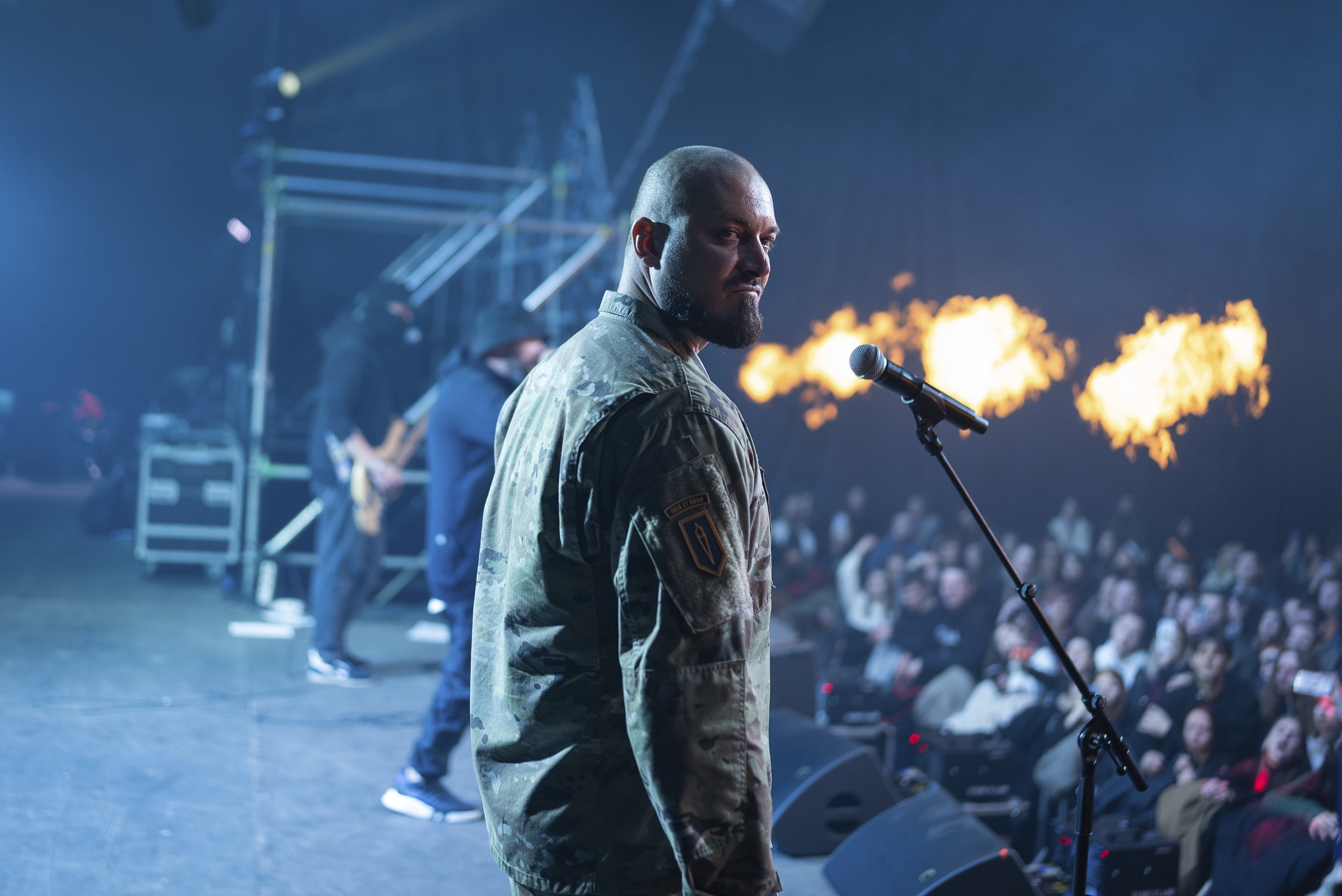 Ukrainian serviceman of 3rd Assault Brigade known by call sign "Avdei" performs together with rock band Proroky, during the presentation of the music album Epoch, a collaboration between Ukrainian artists and the 3rd Assault Brigade, in Kyiv, Ukraine, Saturday, Dec. 7, 2024. (AP Photo/Alex Babenko)