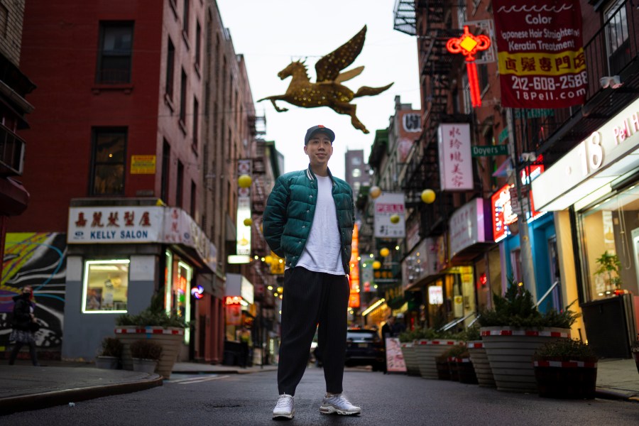 Karho Leung, 33, one of the founders of 12 Pell, a local barbershop, stands for his portrait on Pell Street in Manhattan's Chinatown neighborhood, Thursday, Jan. 25, 2024, in New York. Anchored in the Chinatown community and equally at home elsewhere in the city, Leung says he's "building the world that I want to live in… not asking for permission." (AP Photo/John Minchillo)