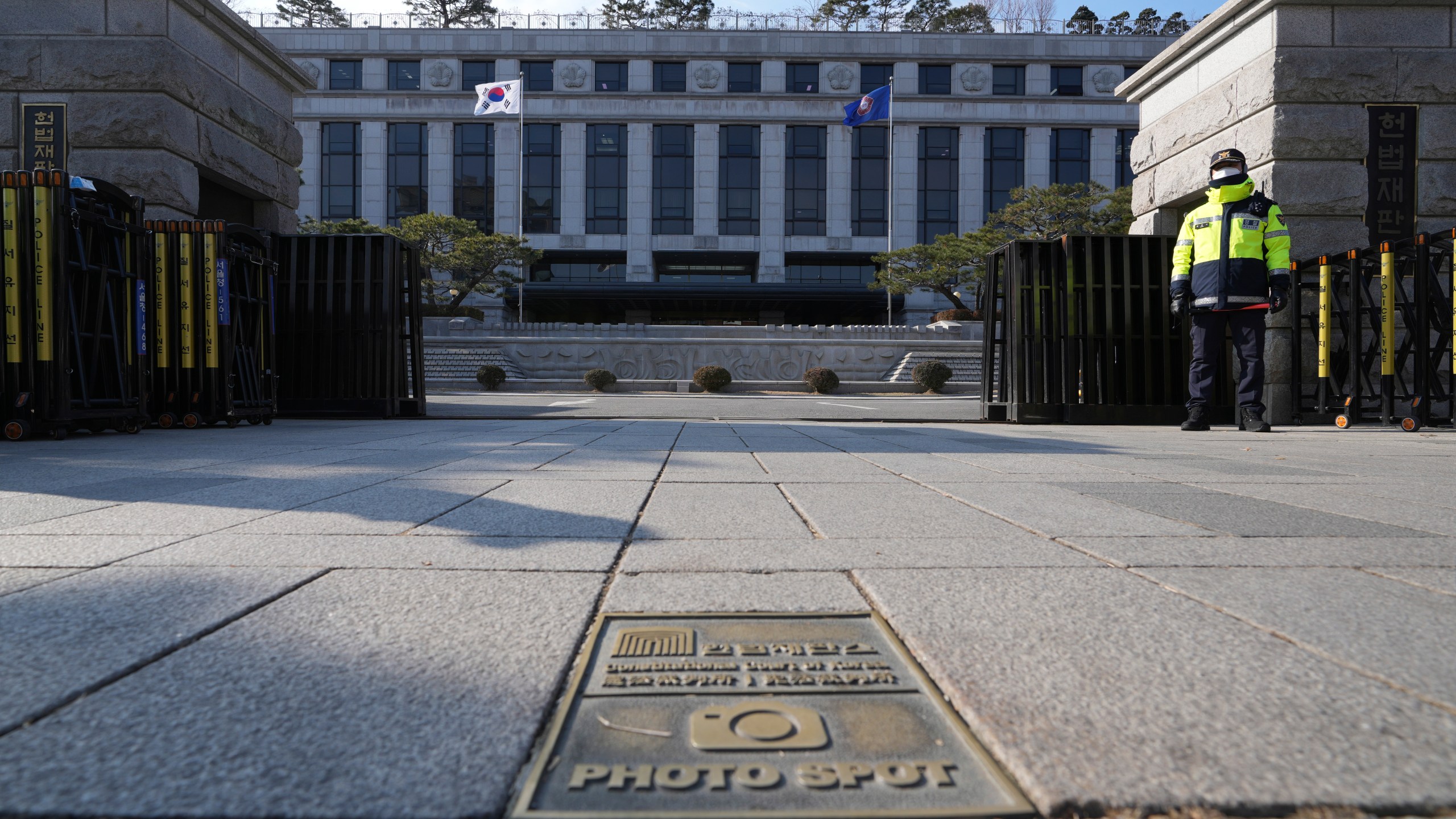 A South Korean police officer stands in front of the Constitutional Court in Seoul, South Korea, Tuesday, Dec. 17, 2024. (AP Photo/Lee Jin-man)