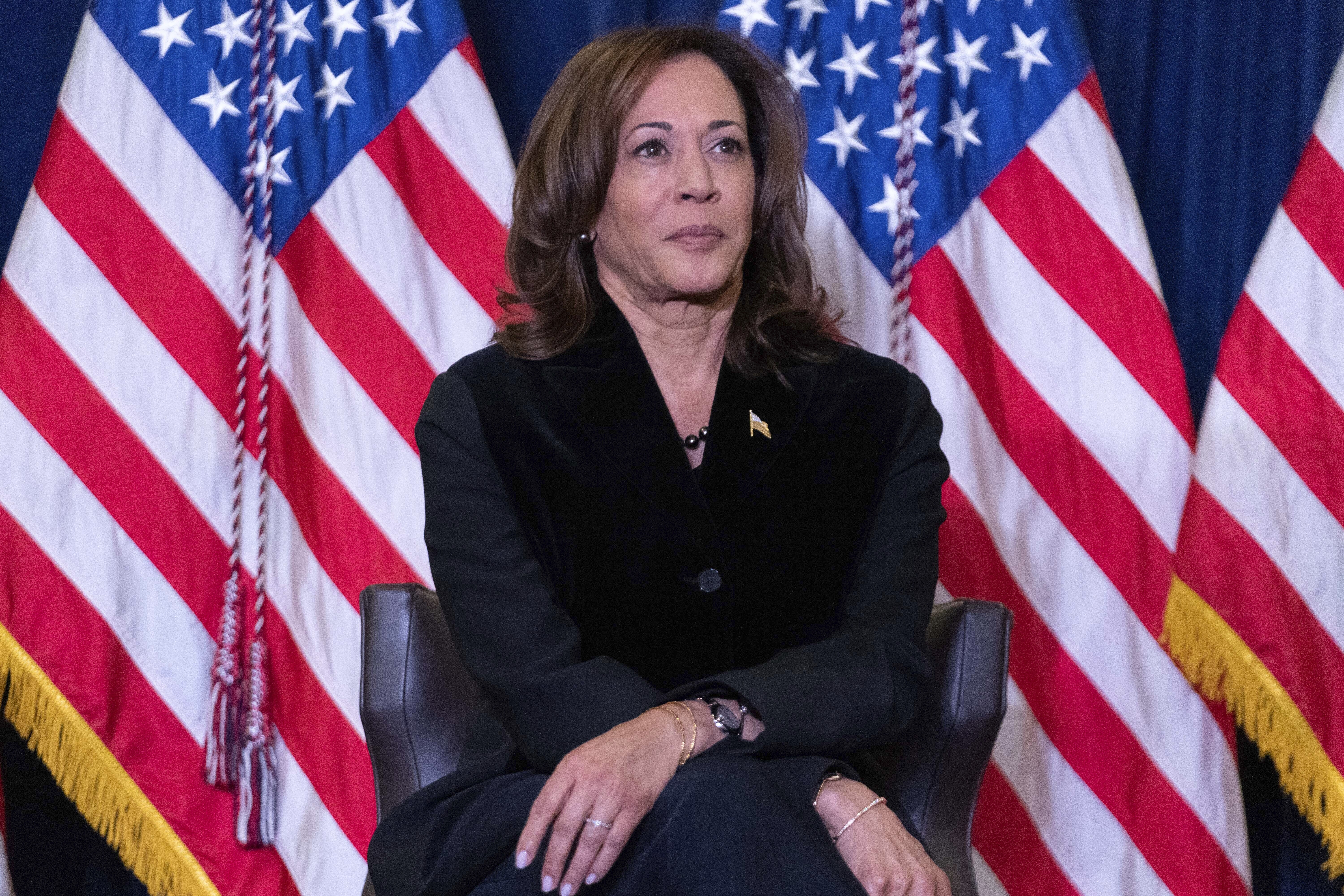 Vice President Kamala Harris listens as first lady Jill Biden speaks at the Democratic National Committee's Holiday Reception at Willard Hotel in Washington, Sunday, Dec. 15, 2024. (AP Photo/Jose Luis Magana)