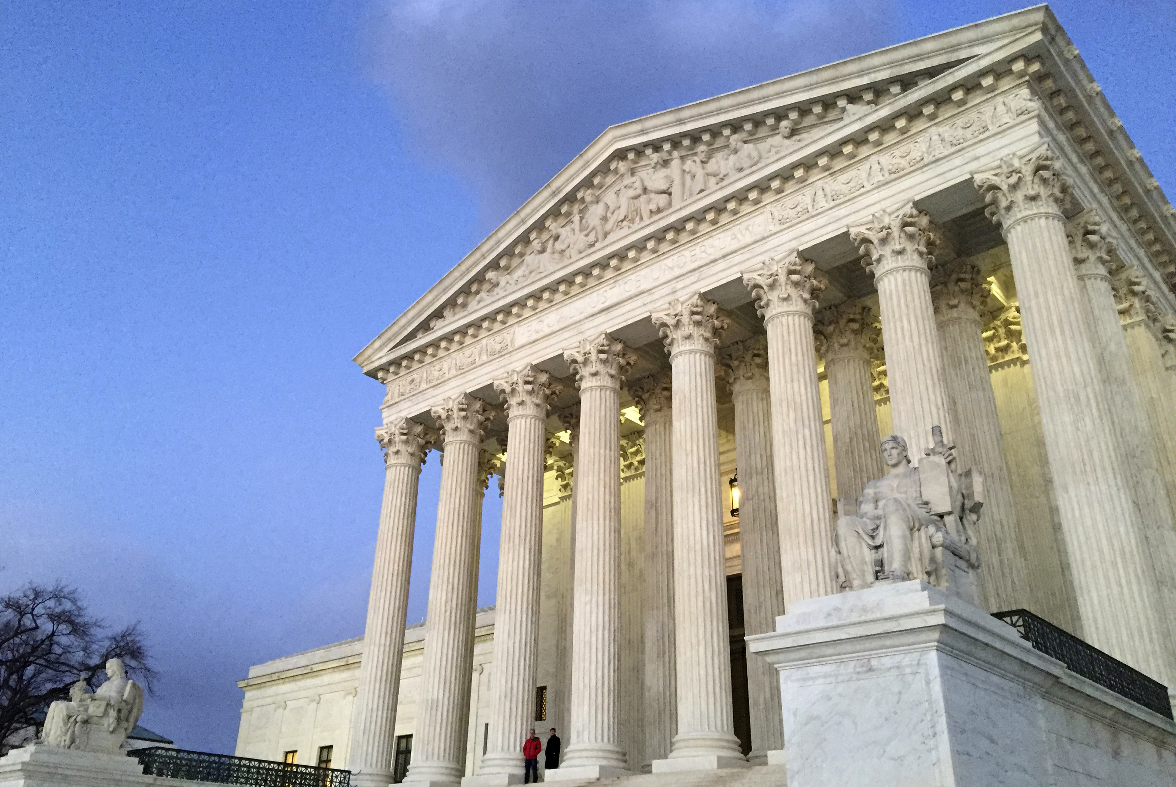 FILE - People stand on the steps of the Supreme Court at sunset in Washington, Feb. 13, 2016. (AP Photo/Jon Elswick, File)