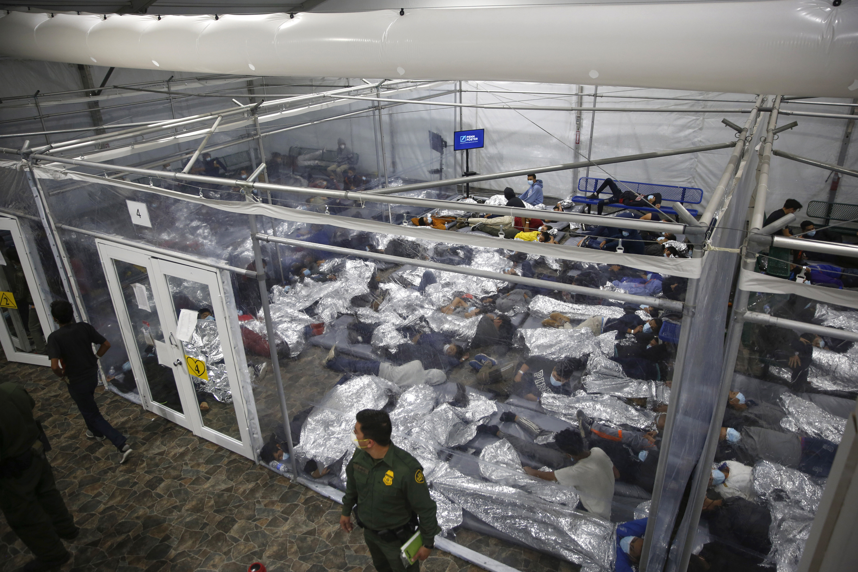 FILE - In this March 30, 2021, file photo, young minors lie inside a pod at the Donna Department of Homeland Security holding facility, the main detention center for unaccompanied children in the Rio Grande Valley run by U.S. Customs and Border Protection (CBP), in Donna, Texas. (AP Photo/Dario Lopez-Mills, Pool, File)