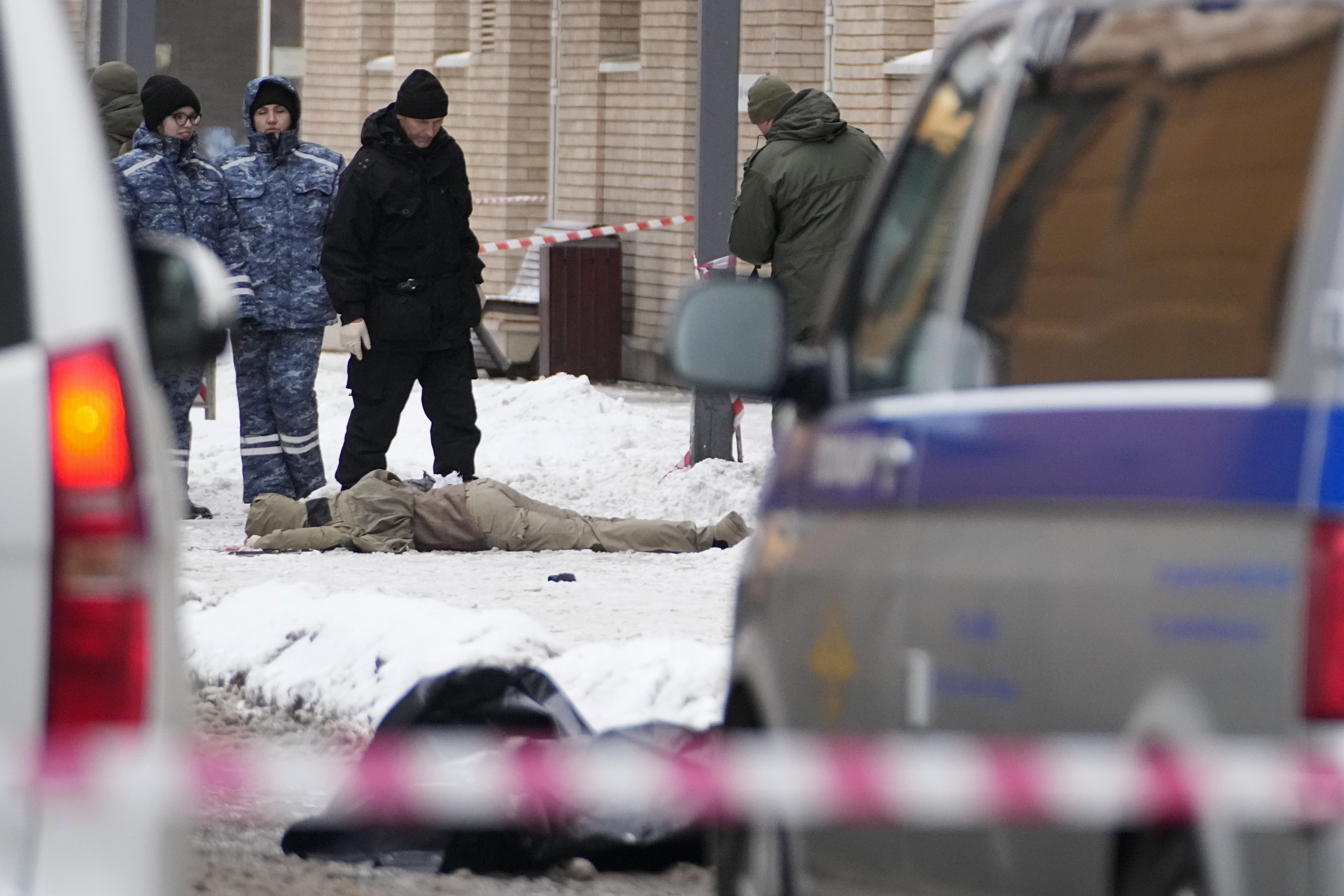 Investigators work at the place where Lt. General Igor Kirillov, the head of Russia's Nuclear, Biological, and Chemical Defence Forces and his assistant, seen at lower center, were killed by an explosive device planted close to a residential apartment's block in Moscow, Russia, Tuesday, Dec. 17, 2024. (AP Photo)