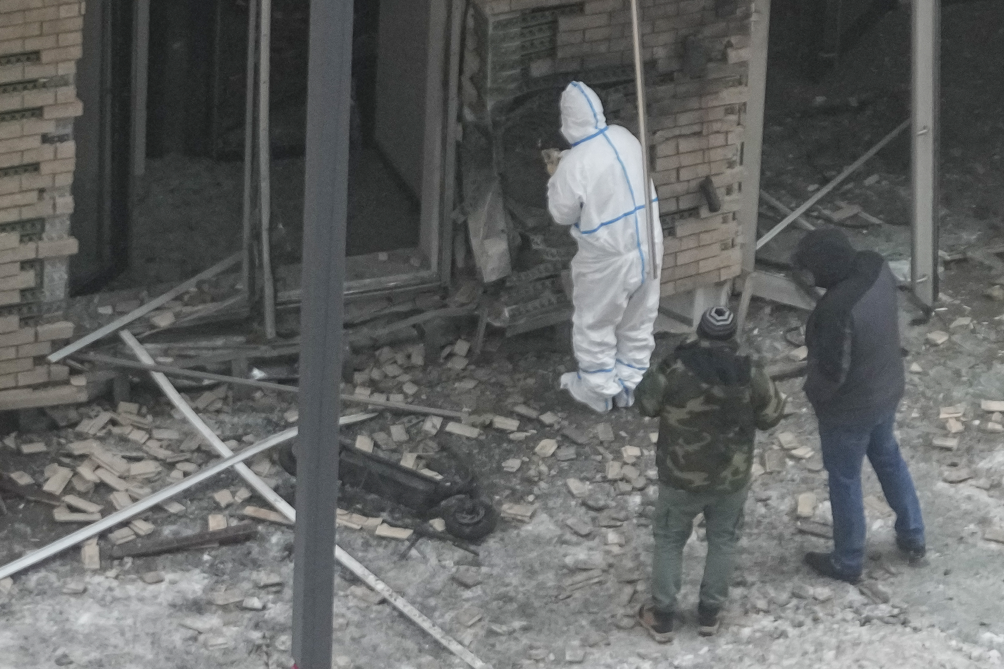 Investigators work near a scooter at the place where Lt. General Igor Kirillov, the head of Russia's Nuclear, Biological, and Chemical Defence Forces and his assistant Ilya Polikarpov were killed by an explosive device planted close to a residential apartment's block in Moscow, Russia, Tuesday, Dec. 17, 2024. (AP Photo)