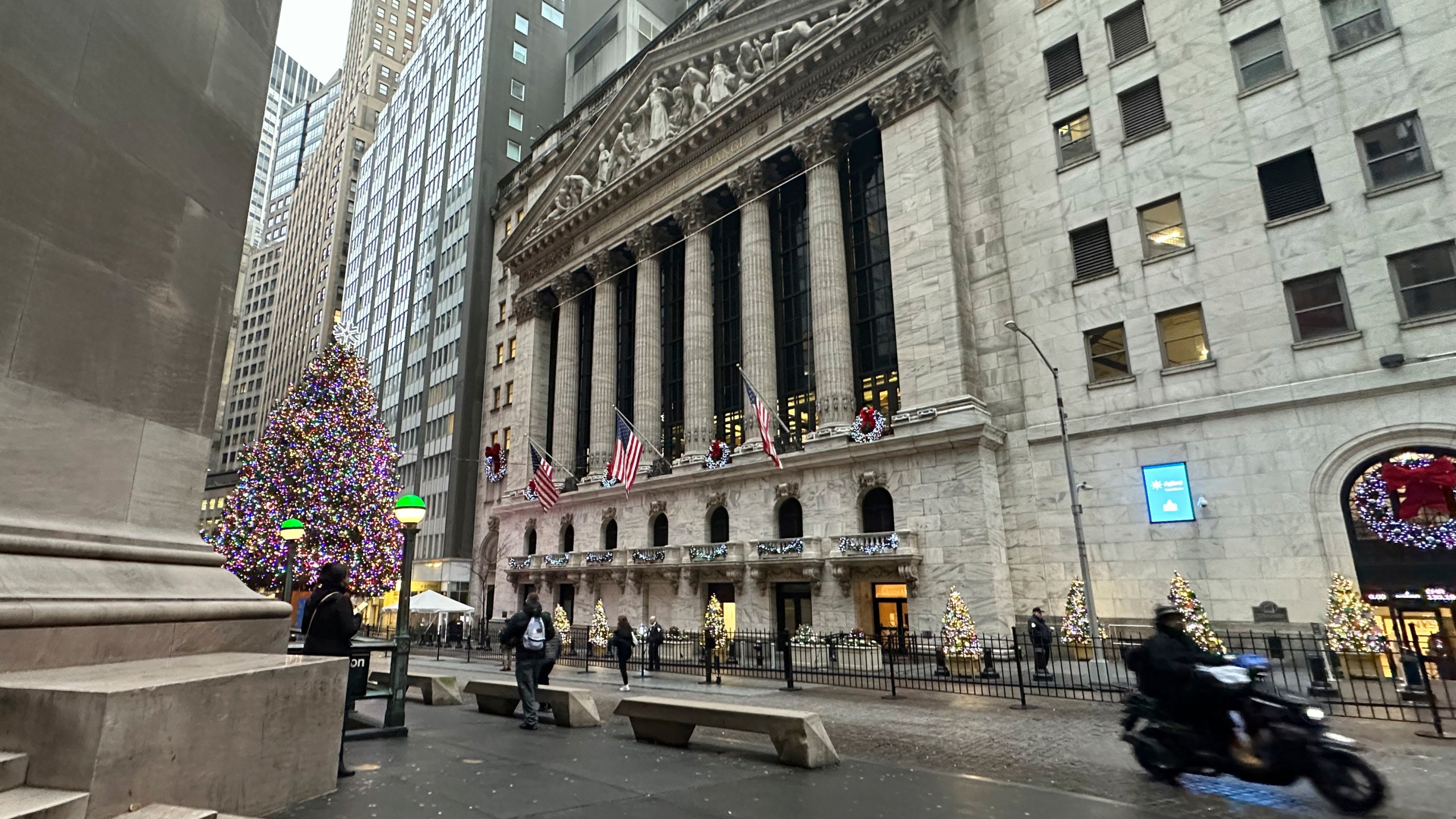 A scooter passes the New York Stock Exchange in New York's Financial District on Tuesday, Dec. 17, 2024. (AP Photo/Peter Morgan)