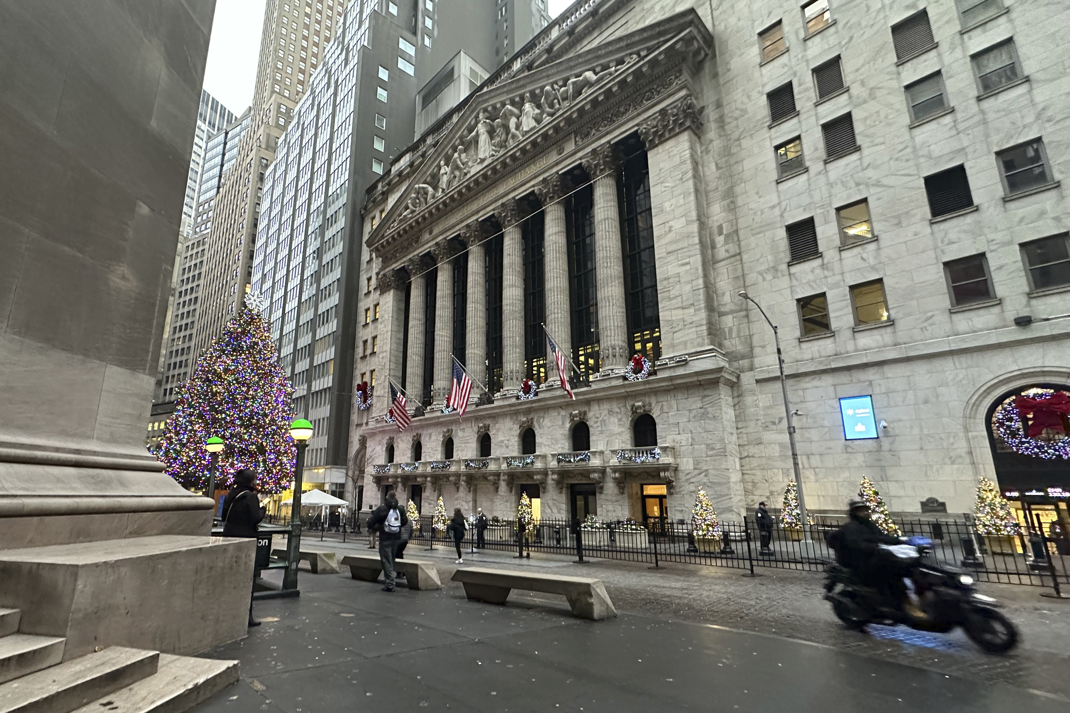 A scooter passes the New York Stock Exchange in New York's Financial District on Tuesday, Dec. 17, 2024. (AP Photo/Peter Morgan)