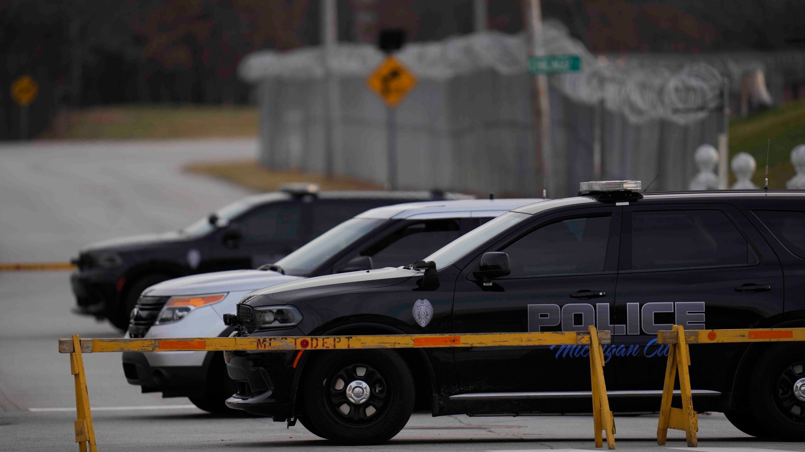 Police cars are parked outside of Indiana State Prison on Tuesday, Dec. 17, 2024, in Michigan City, Ind., where, barring last-minute court action or intervention by Gov. Eric Holcomb, Joseph Corcoran, 49, convicted in the 1997 killings of his brother and three other people, is scheduled to be put to death by lethal injection before sunrise Wednesday, Dec. 18. (AP Photo/Erin Hooley)