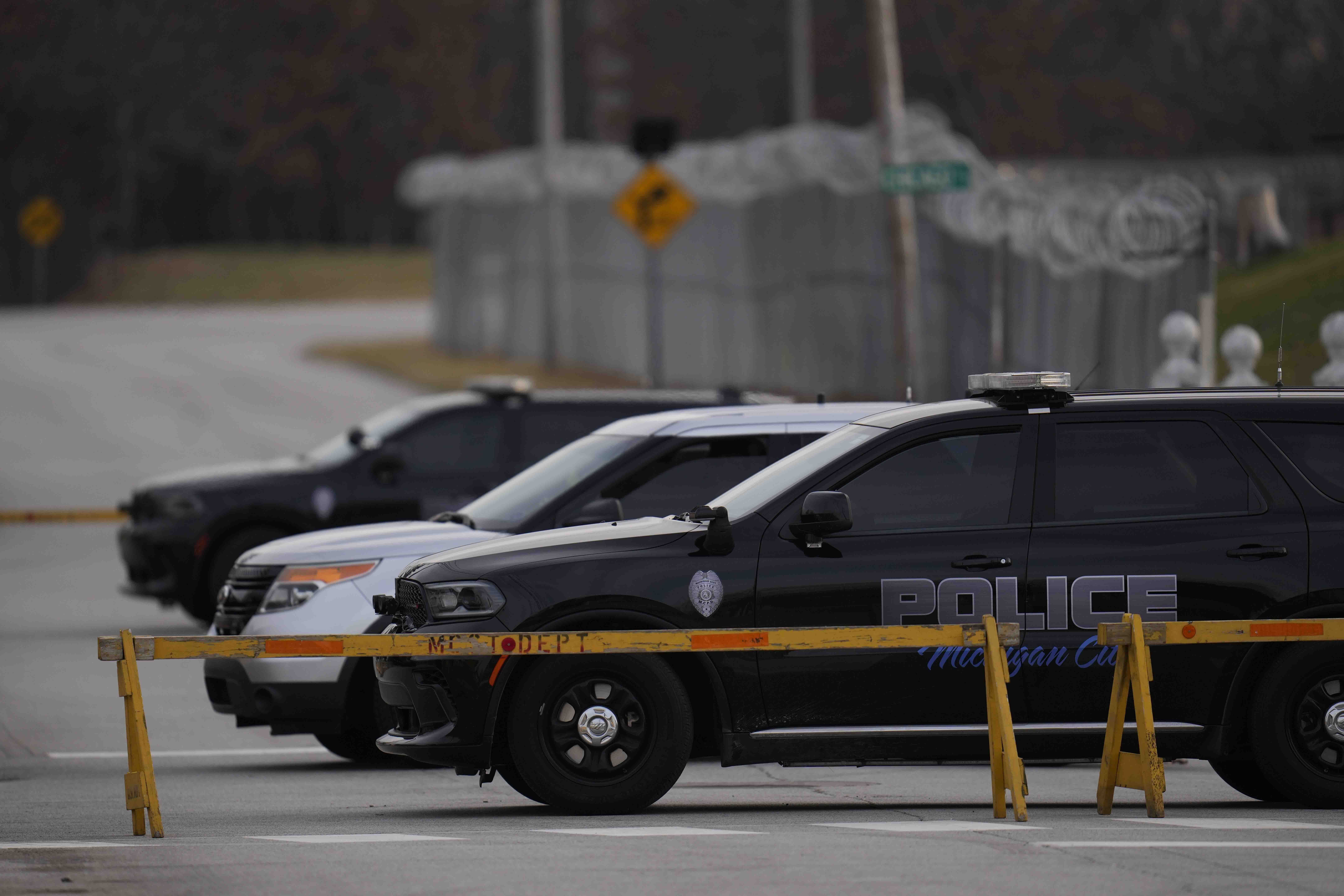 Police cars are parked outside of Indiana State Prison on Tuesday, Dec. 17, 2024, in Michigan City, Ind., where, barring last-minute court action or intervention by Gov. Eric Holcomb, Joseph Corcoran, 49, convicted in the 1997 killings of his brother and three other people, is scheduled to be put to death by lethal injection before sunrise Wednesday, Dec. 18. (AP Photo/Erin Hooley)