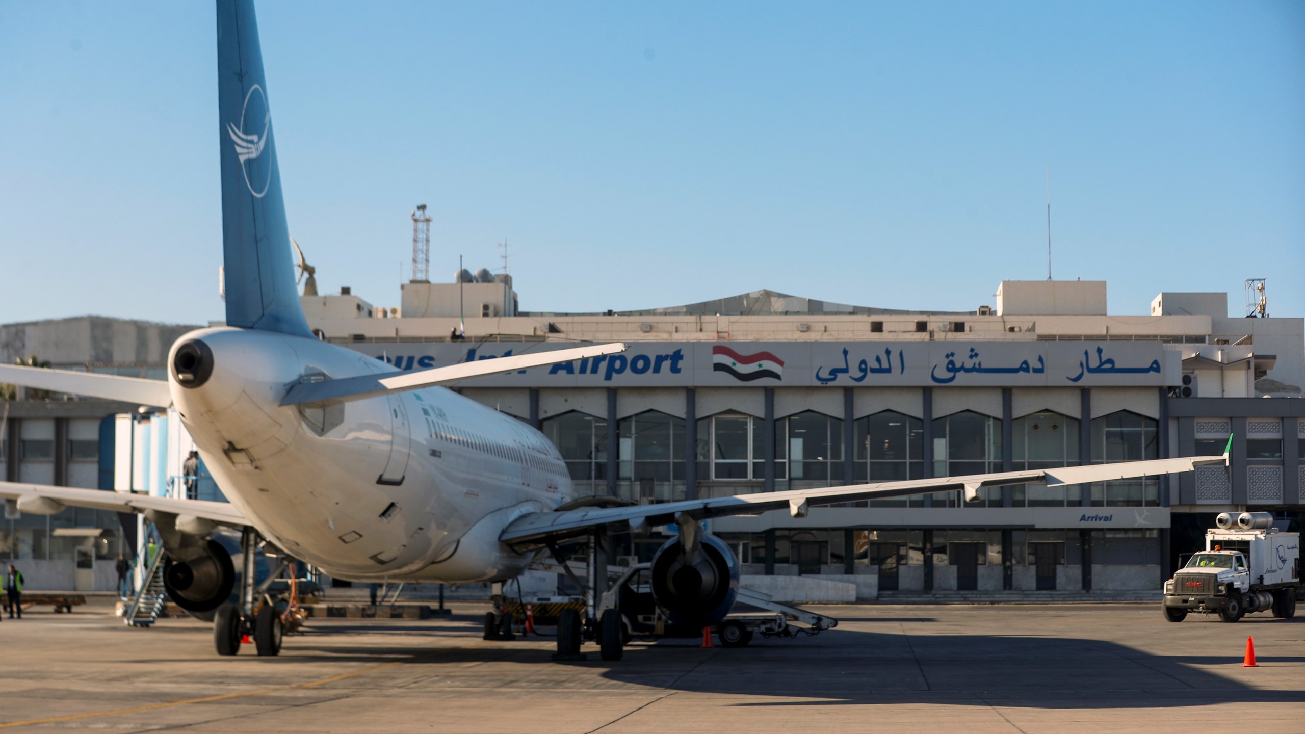 A Syrian Air airplane is seen parked at the terminal as the airport reopens for internal flights in Damascus, Syria, Wednesday, Dec. 18, 2024. (AP Photo/Omar Sanadiki)