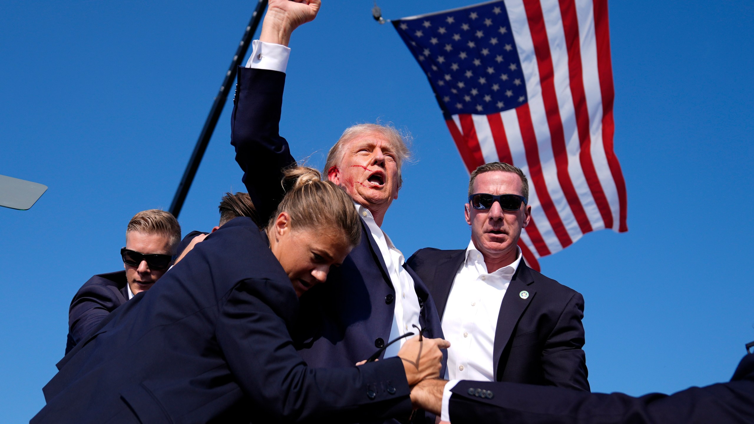 FILE - Republican presidential candidate former President Donald Trump is surrounded by U.S. Secret Service agents after an assassination attempt at a campaign rally in Butler, Pa., July 13, 2024. (AP Photo/Evan Vucci, File)