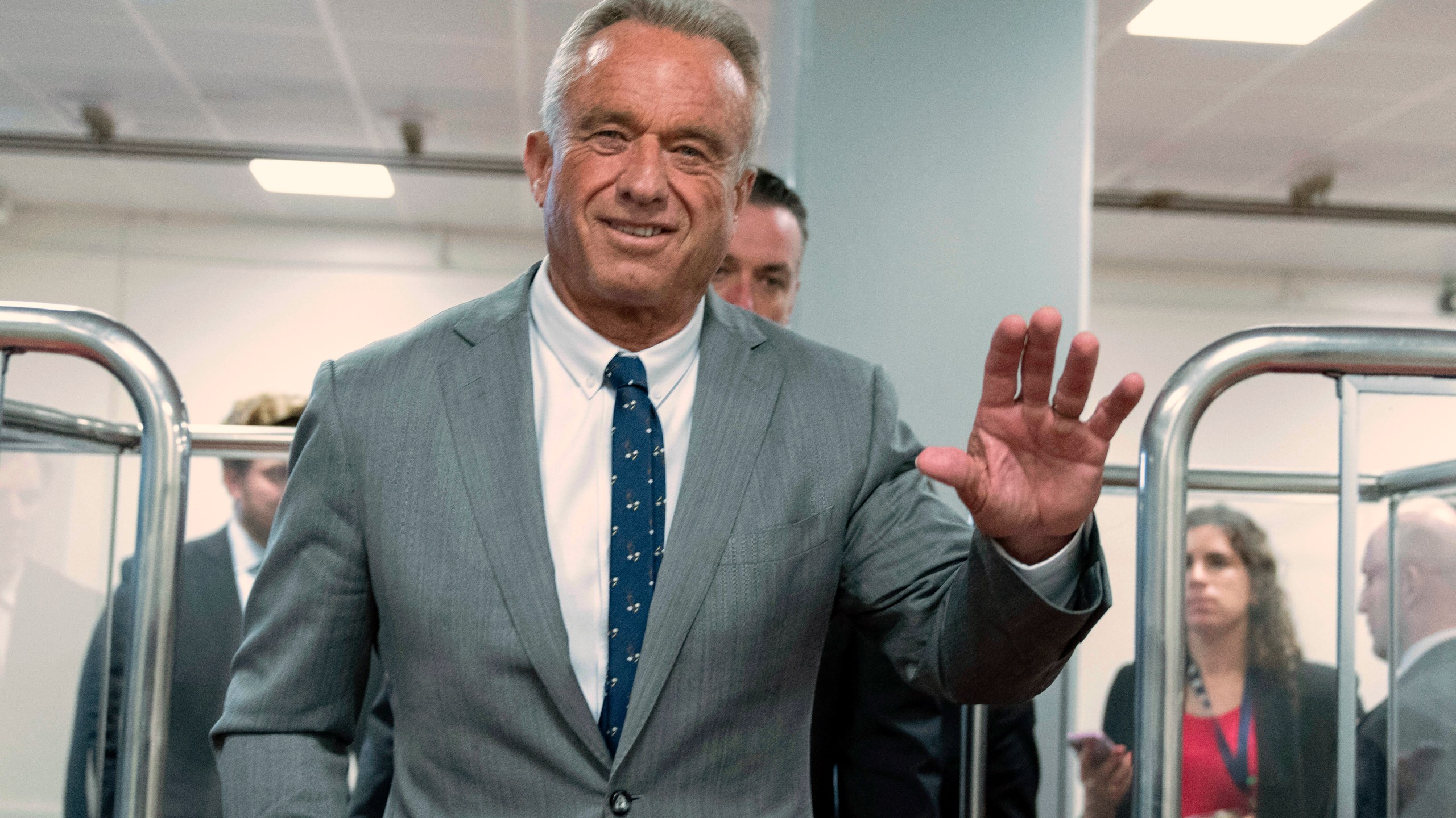 Robert F. Kennedy Jr., President-elect Donald Trump's nominee to be Secretary of Health and Human Services, waves to the media as he rides the train to go to meet with Sen. John Thune, R-S.D. at the Capitol in Washington, Tuesday, Dec. 17, 2024. (AP Photo/Jose Luis Magana)