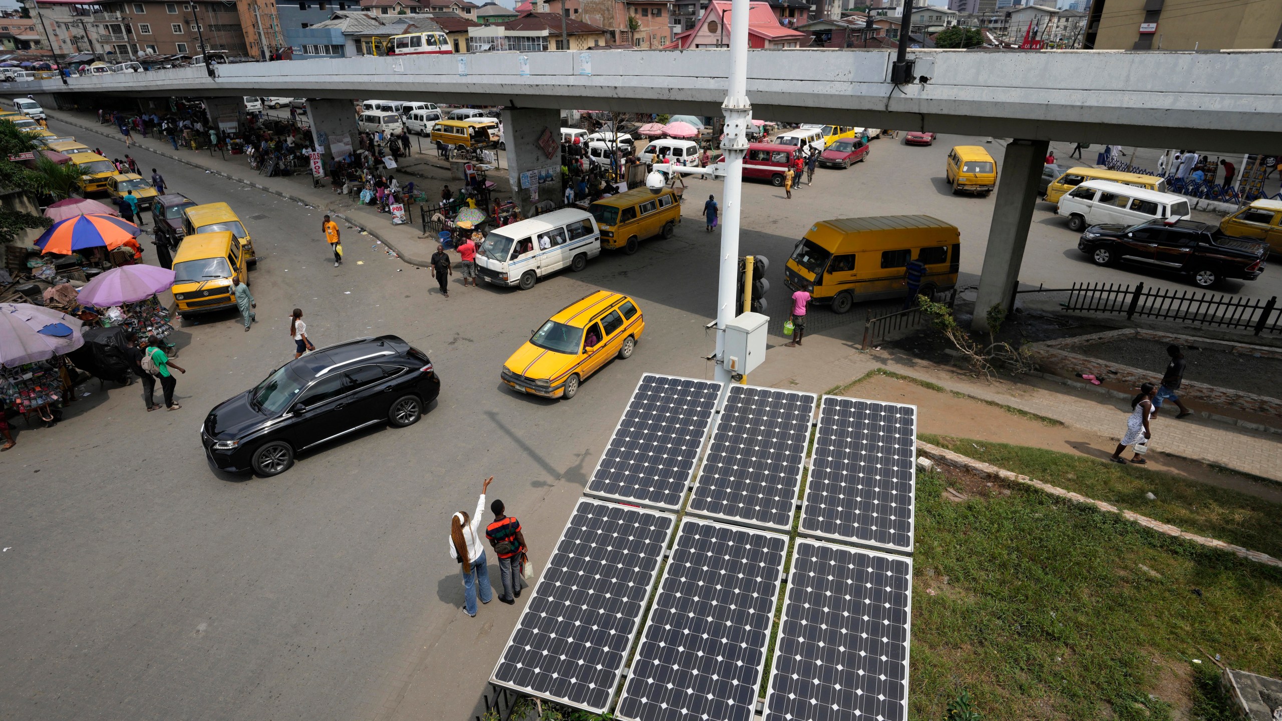 FILE - Solar panels operate near a street in the Obalende neighborhood of Lagos, Nigeria, Aug. 20, 2022. (AP Photo/Sunday Alamba, File)