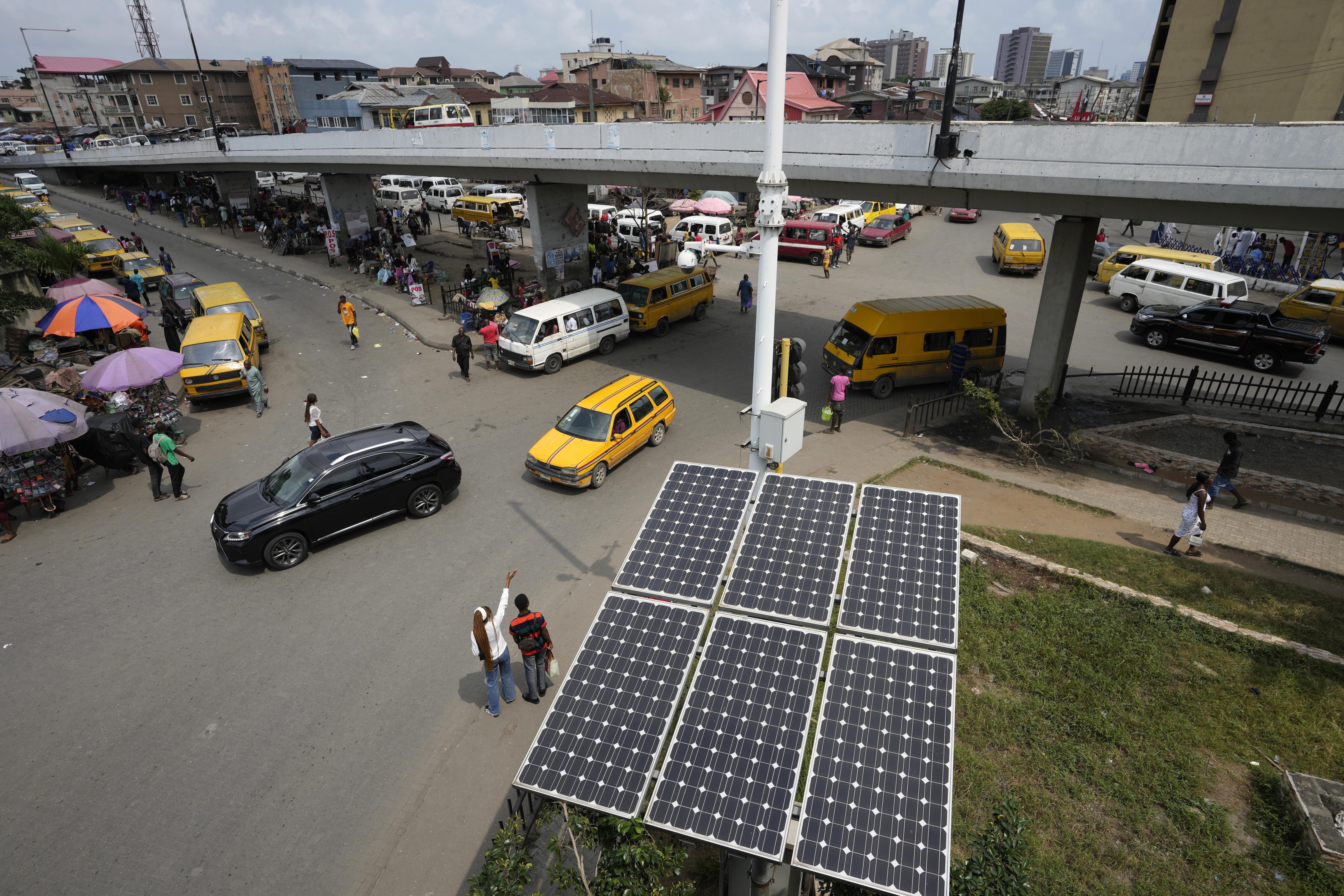 FILE - Solar panels operate near a street in the Obalende neighborhood of Lagos, Nigeria, Aug. 20, 2022. (AP Photo/Sunday Alamba, File)