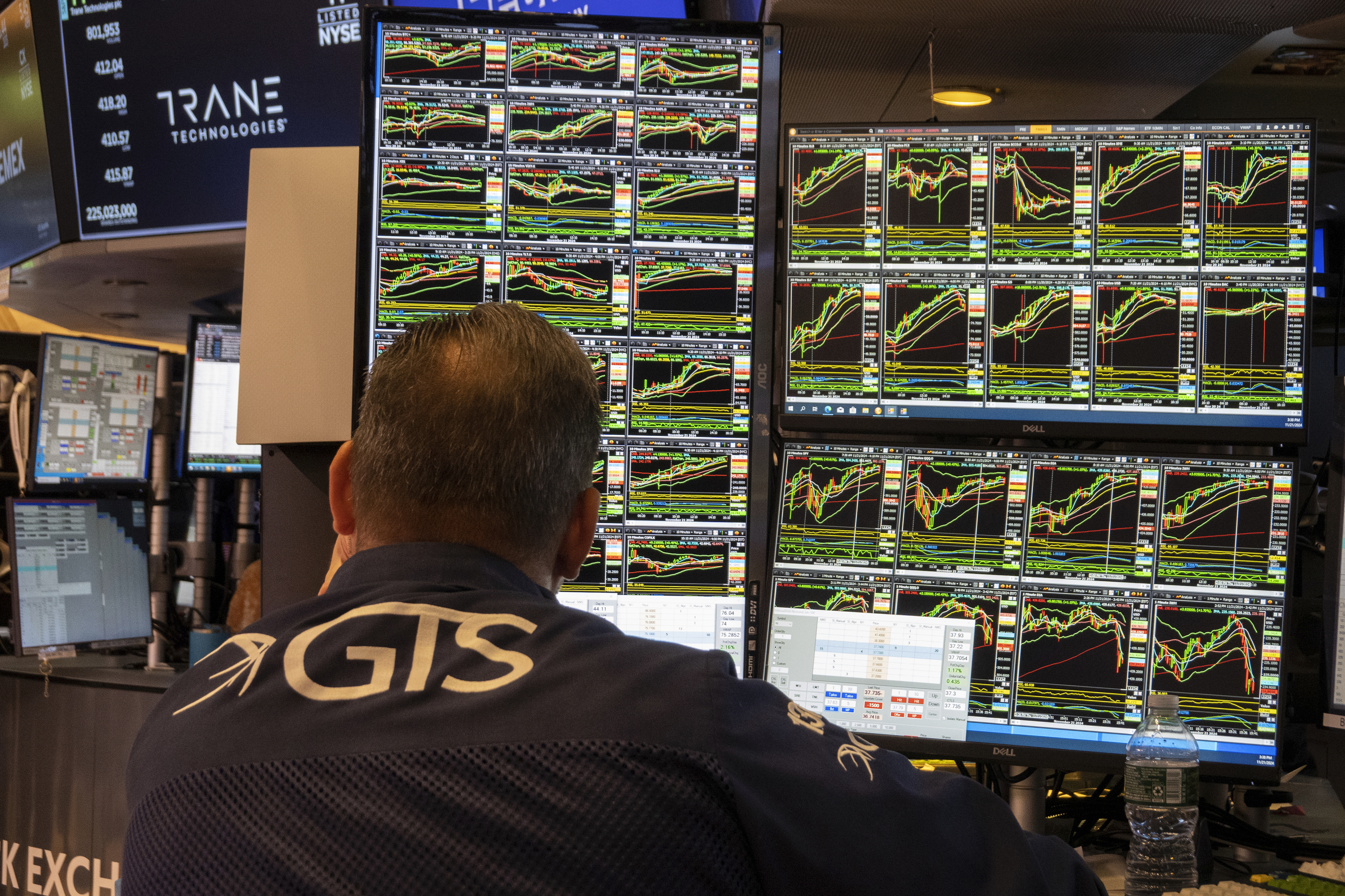 FILE - A specialist studies monitors on the New York Stock Exchange trading floor in New York on November 21, 2024. (AP Photo/Ted Shaffrey, File)