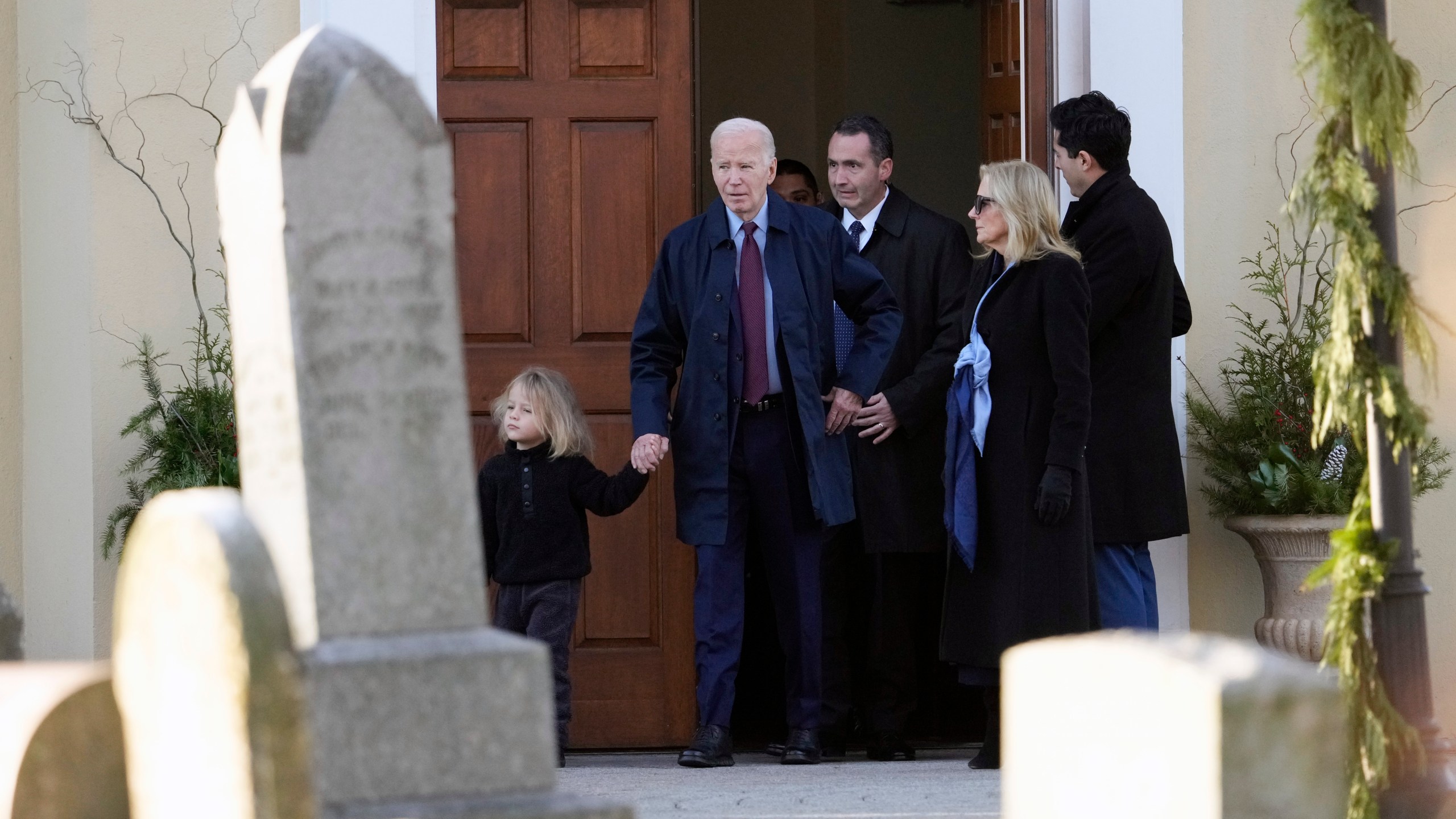 President Joe Biden, first lady Jill Biden and grandson Beau Biden step out of Brandywine Catholic Church in Wilmington, Del., on Wednesday, Dec. 18, 2024. Wednesday marks the 52nd anniversary of the car crash that killed Joe Biden's first wife Neilia Hunter Biden and 13-month-old daughter Naomi. (AP Photo/Ben Curtis)