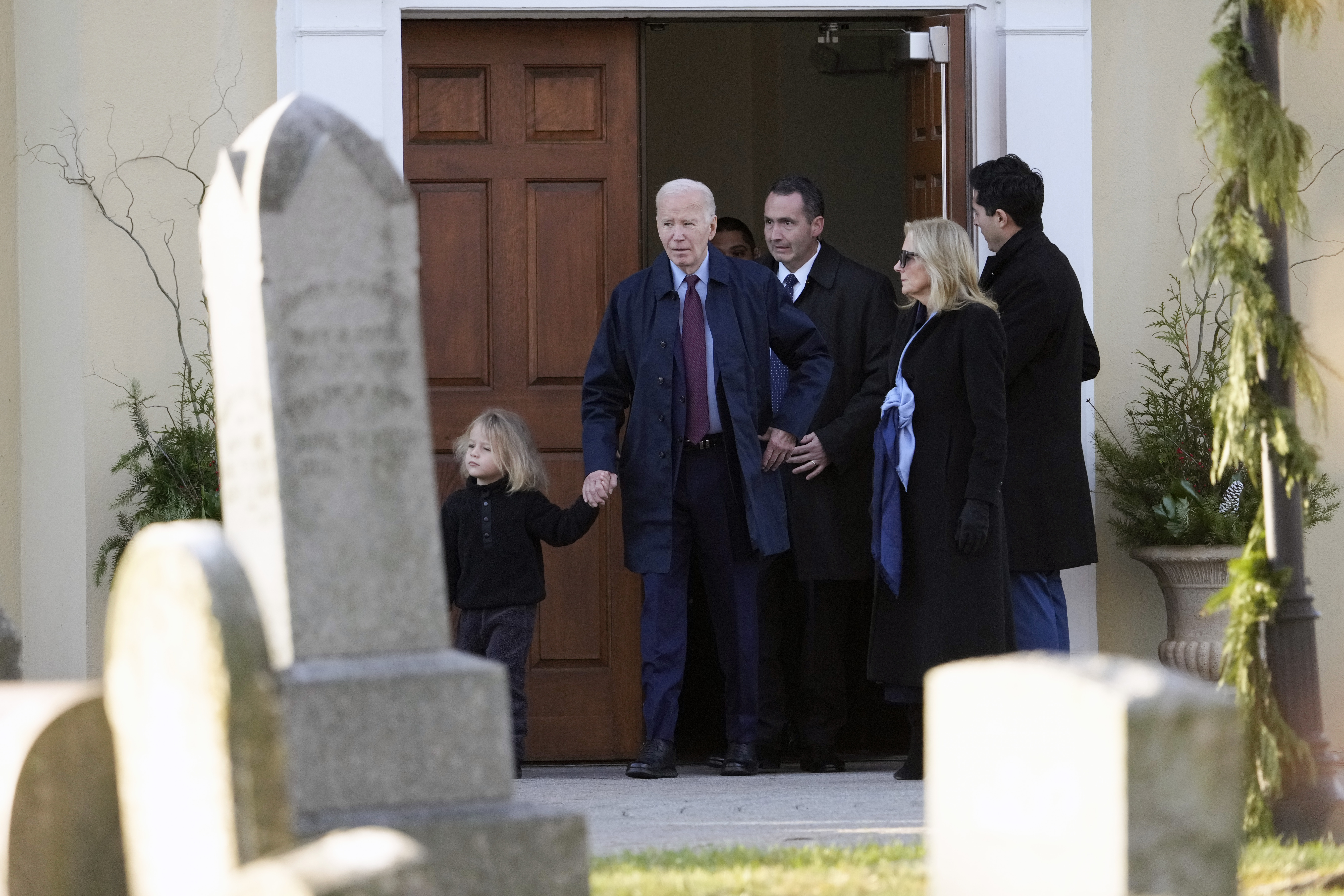 President Joe Biden, first lady Jill Biden and grandson Beau Biden step out of Brandywine Catholic Church in Wilmington, Del., on Wednesday, Dec. 18, 2024. Wednesday marks the 52nd anniversary of the car crash that killed Joe Biden's first wife Neilia Hunter Biden and 13-month-old daughter Naomi. (AP Photo/Ben Curtis)