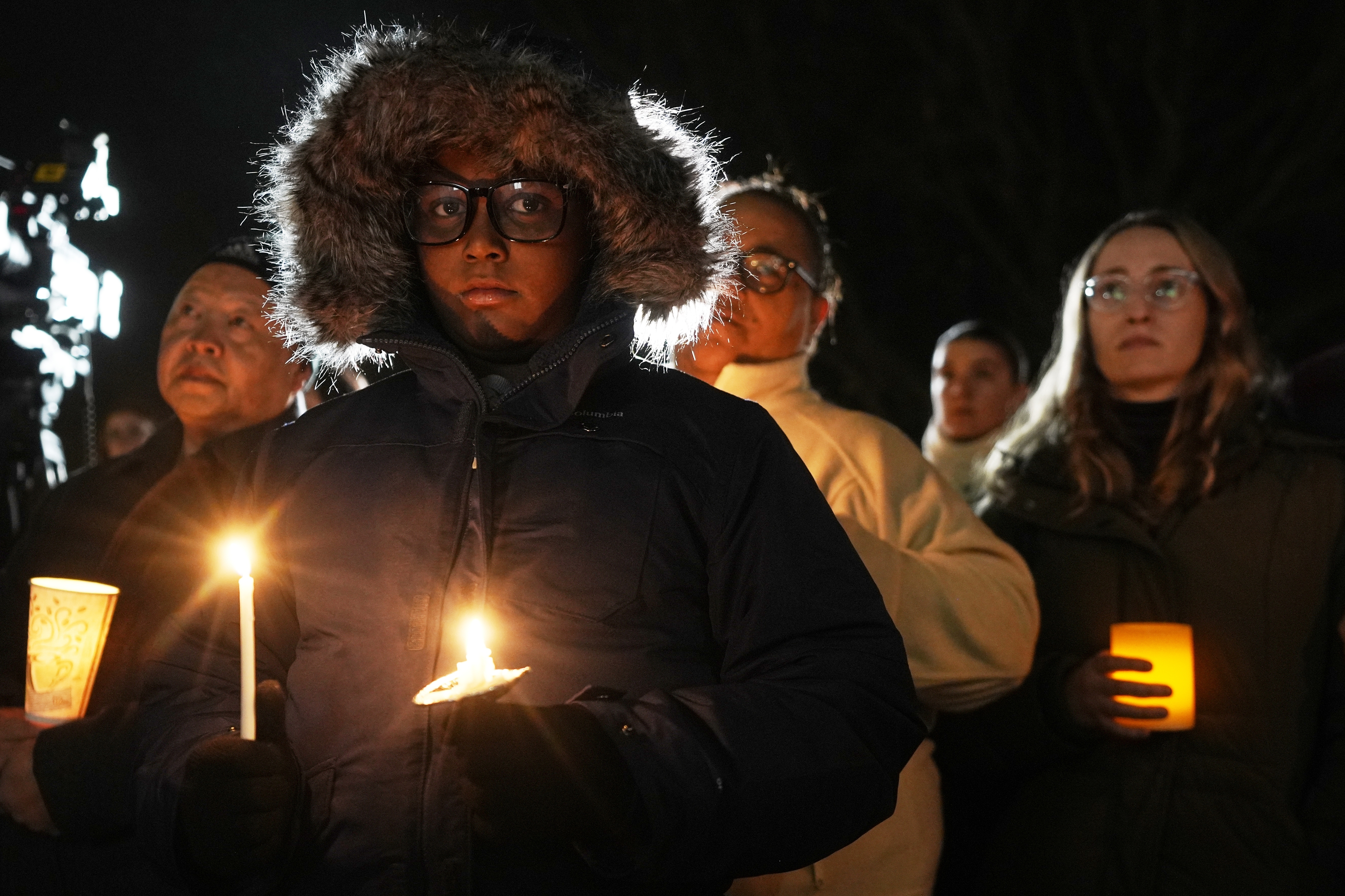 Supporters hold candles during a candlelight vigil Tuesday, Dec. 17, 2024, outside the Wisconsin Capitol in Madison, Wis., following a shooting at the Abundant Life Christian School on Monday, Dec. 16. (AP Photo/Morry Gash)