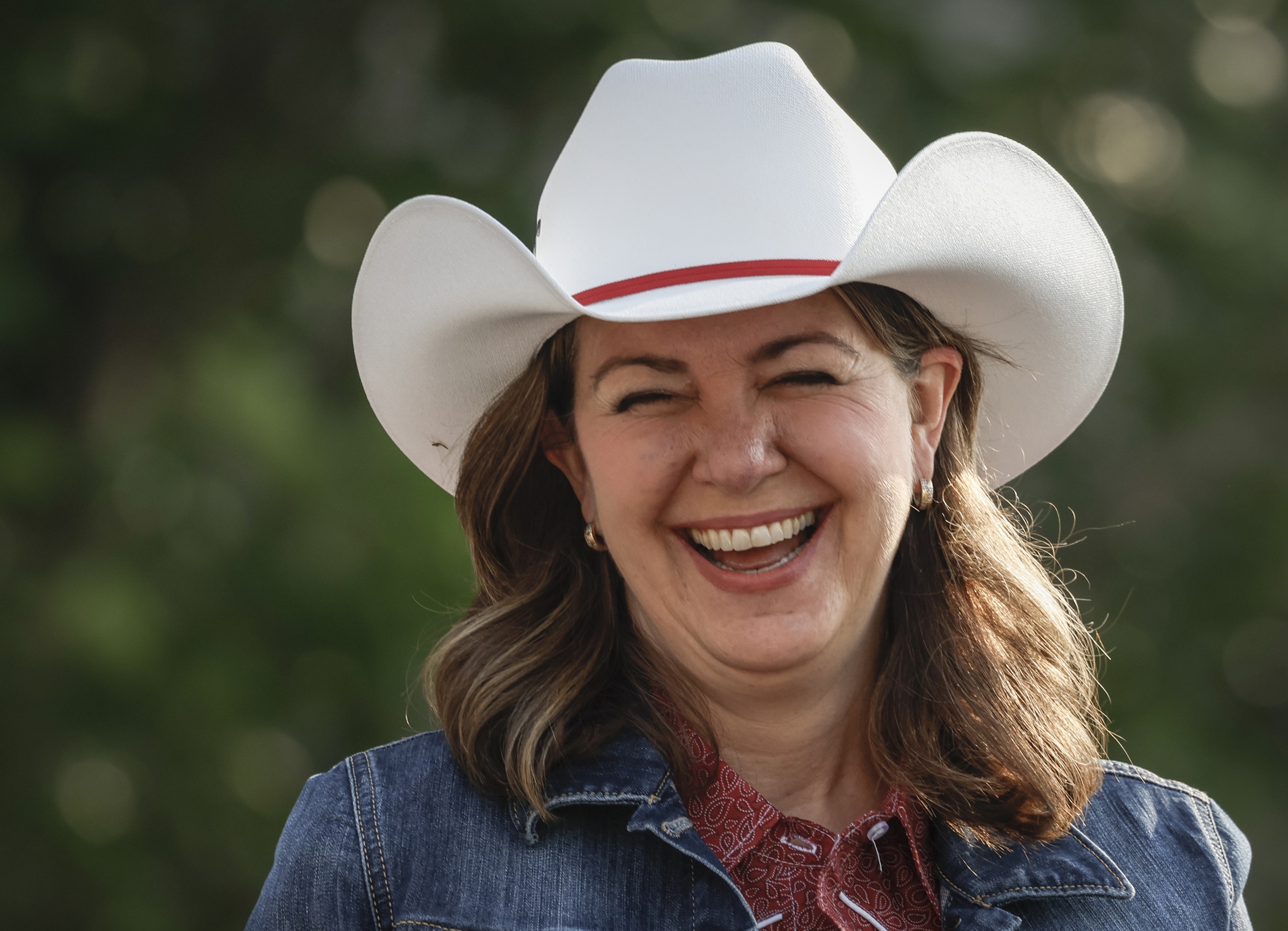 File - Alberta Premier Danielle Smith wears a cowboy hat during the Calgary Stampede parade in Calgary, Friday, July 7, 2023. (Jeff McIntosh /The Canadian Press via AP, File)