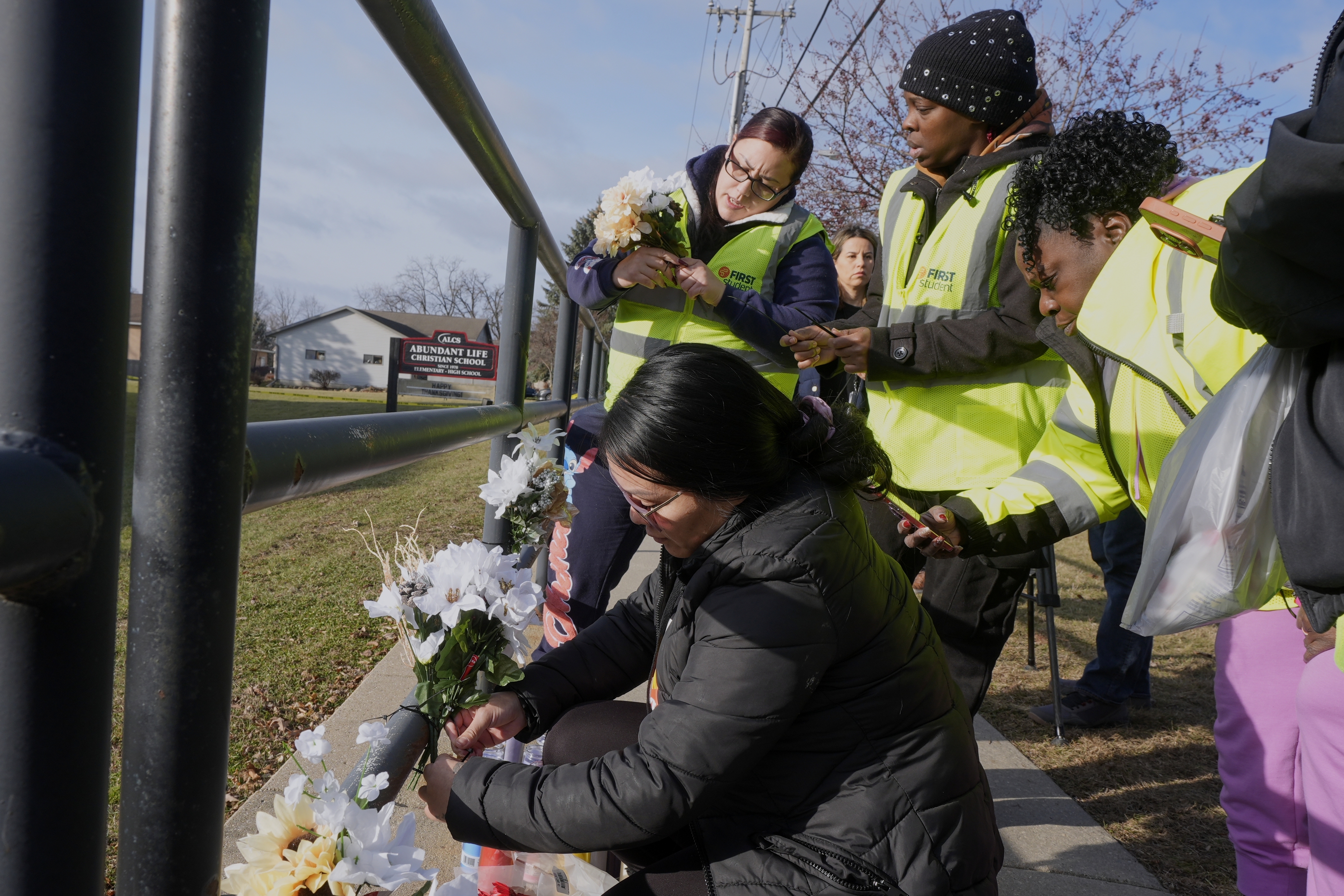 People put flowers outside the Abundant Life Christian School Tuesday, Dec. 17, 2024 in Madison, Wis., following a shooting on Monday. (AP Photo/Morry Gash)