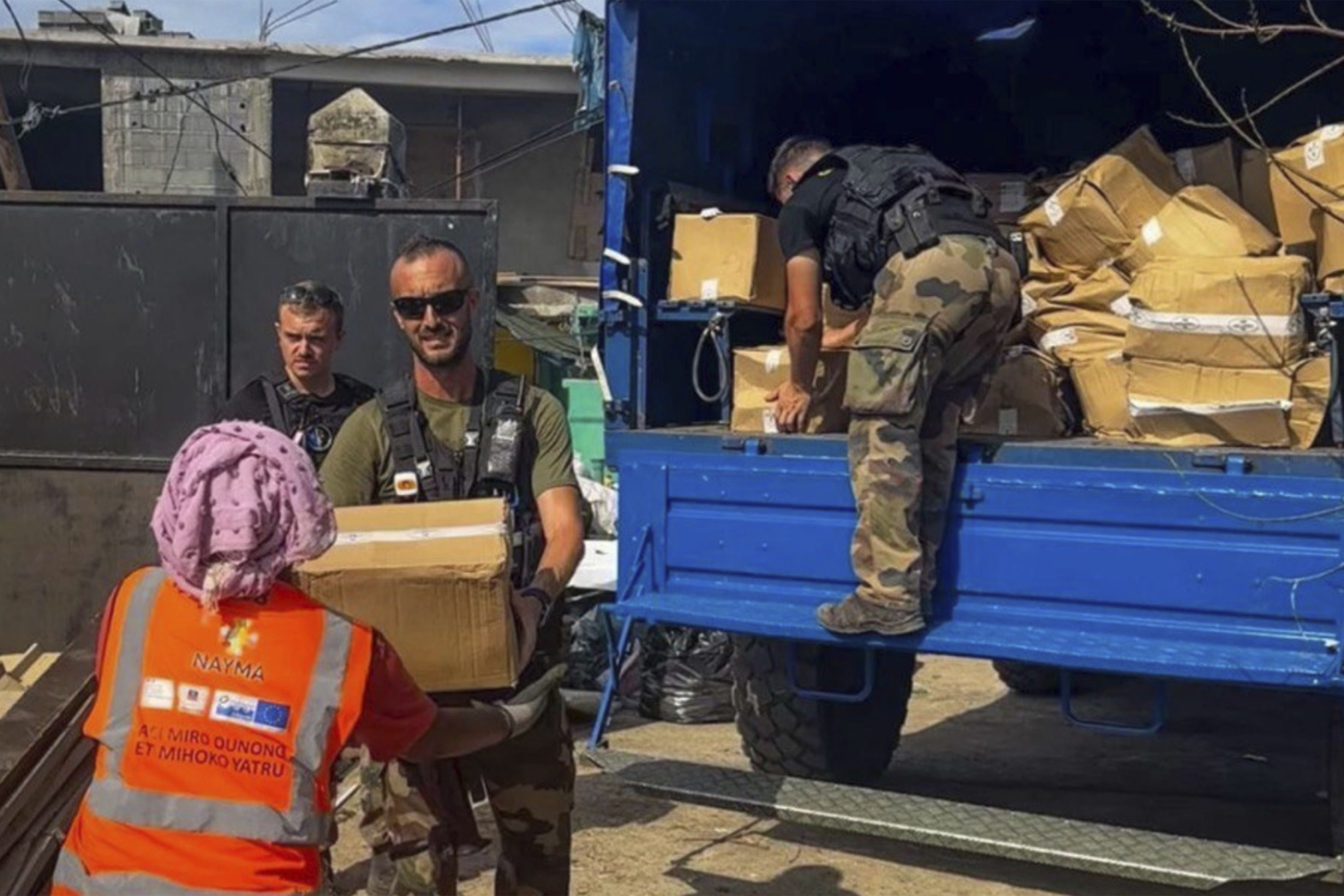 This photo provided by the French Interior Ministry shows French gendarmes unloading supplies in Koungou, in the Indian Ocean French territory of Mayotte, Wednesday Dec.18, 2024. (Ministere de l'Interieur/Gendarmerie Nationale via AP)