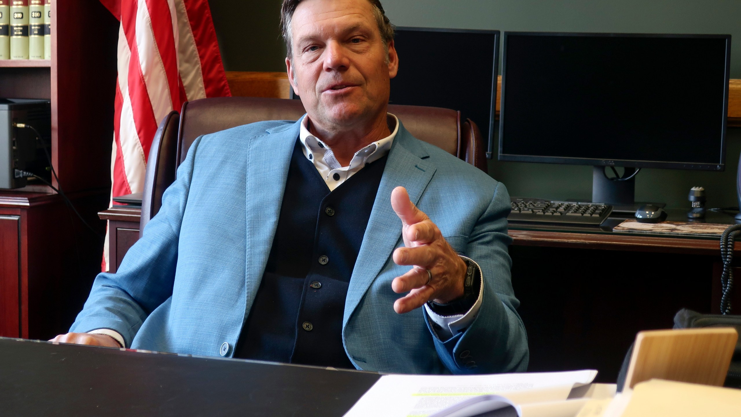 Kansas Attorney General Kris Kobach, who's informally advising President-elect Donald Trump's transition team, discusses immigration issues during an interview with The Associated Press, Wednesday, Dec. 18, 2024, in his office in Topeka, Kan. (AP Photo/John Hanna)