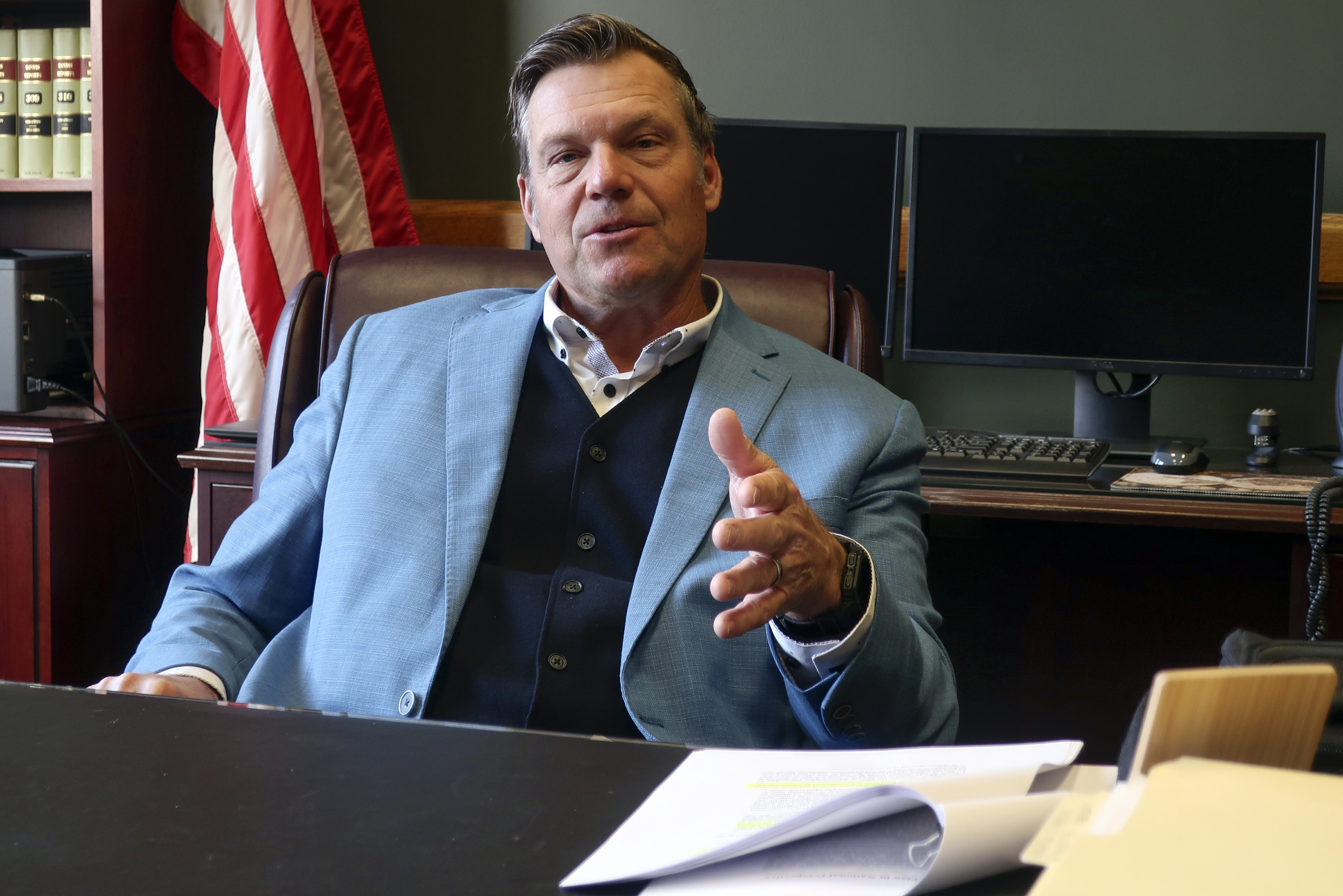 Kansas Attorney General Kris Kobach, who's informally advising President-elect Donald Trump's transition team, discusses immigration issues during an interview with The Associated Press, Wednesday, Dec. 18, 2024, in his office in Topeka, Kan. (AP Photo/John Hanna)