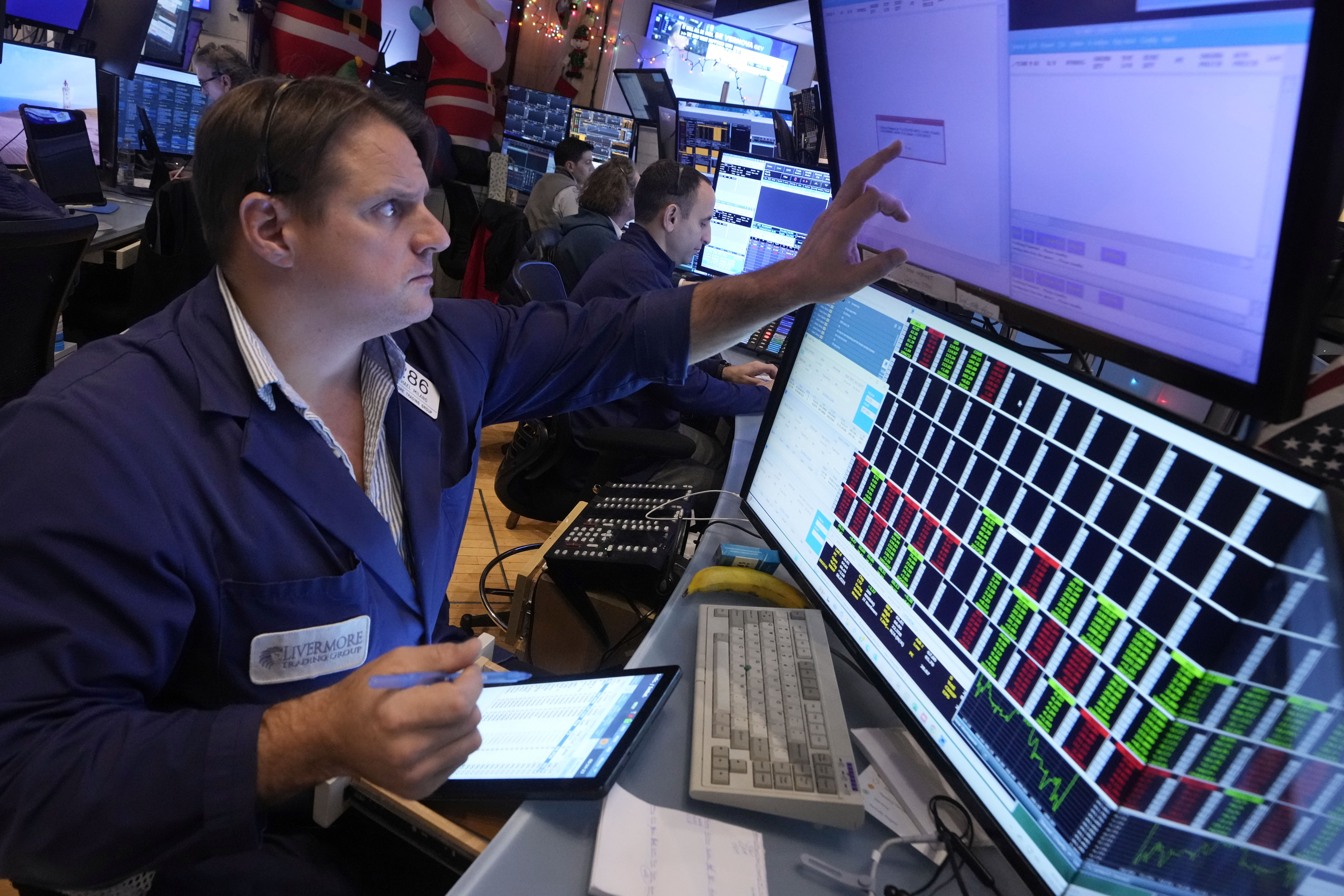 Trader Michael Milano works on the floor of the New York Stock Exchange, Wednesday, Dec. 18, 2024. (AP Photo/Richard Drew)