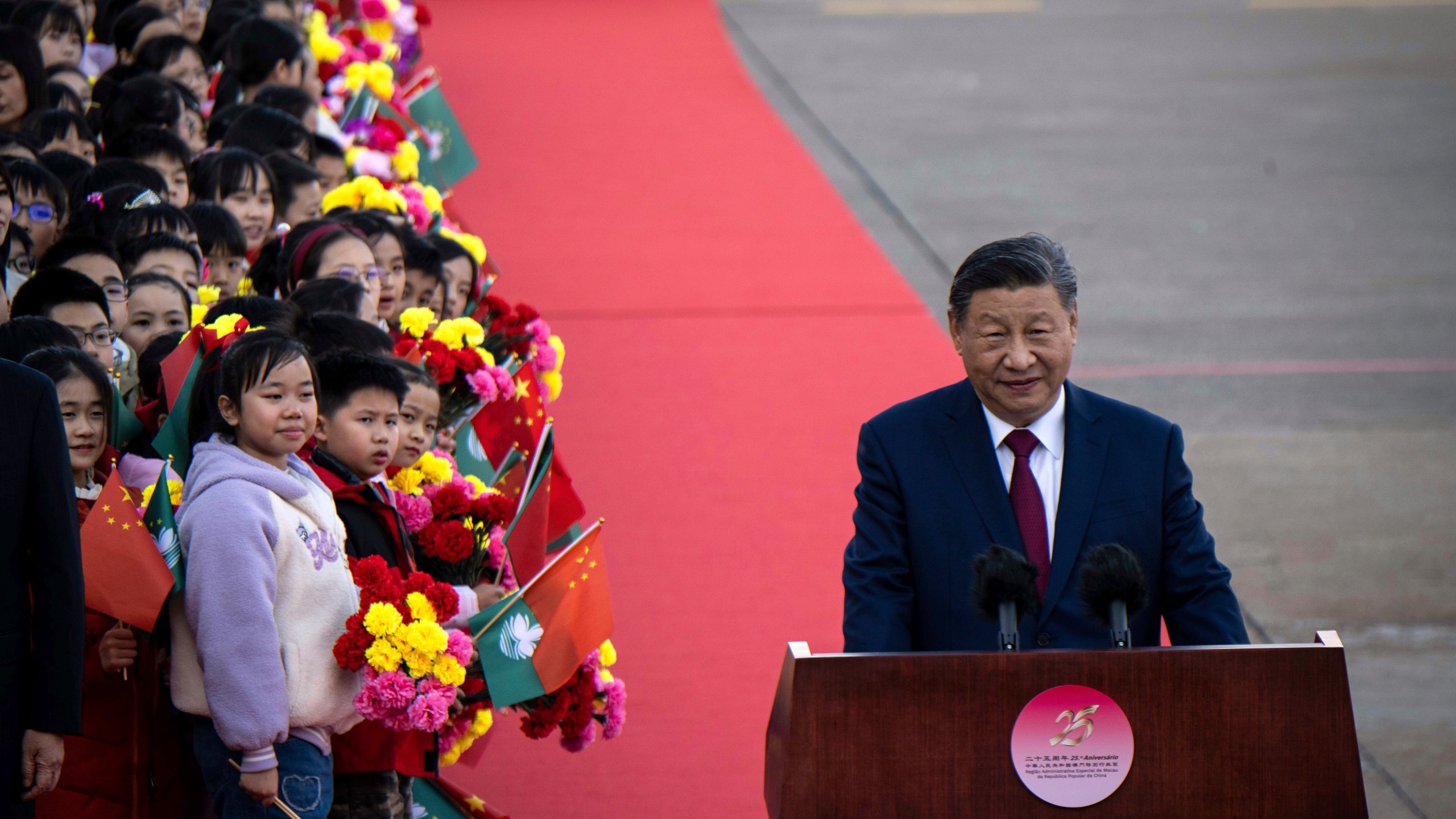 China's President Xi Jinping, right, speaks upon his arrival at the airport in Macao, China, Wednesday, Dec. 18, 2024, ahead of celebrations marking the 25th anniversary of the casino city’s return to Chinese rule. (Eduardo Leal/Pool Photo via AP)