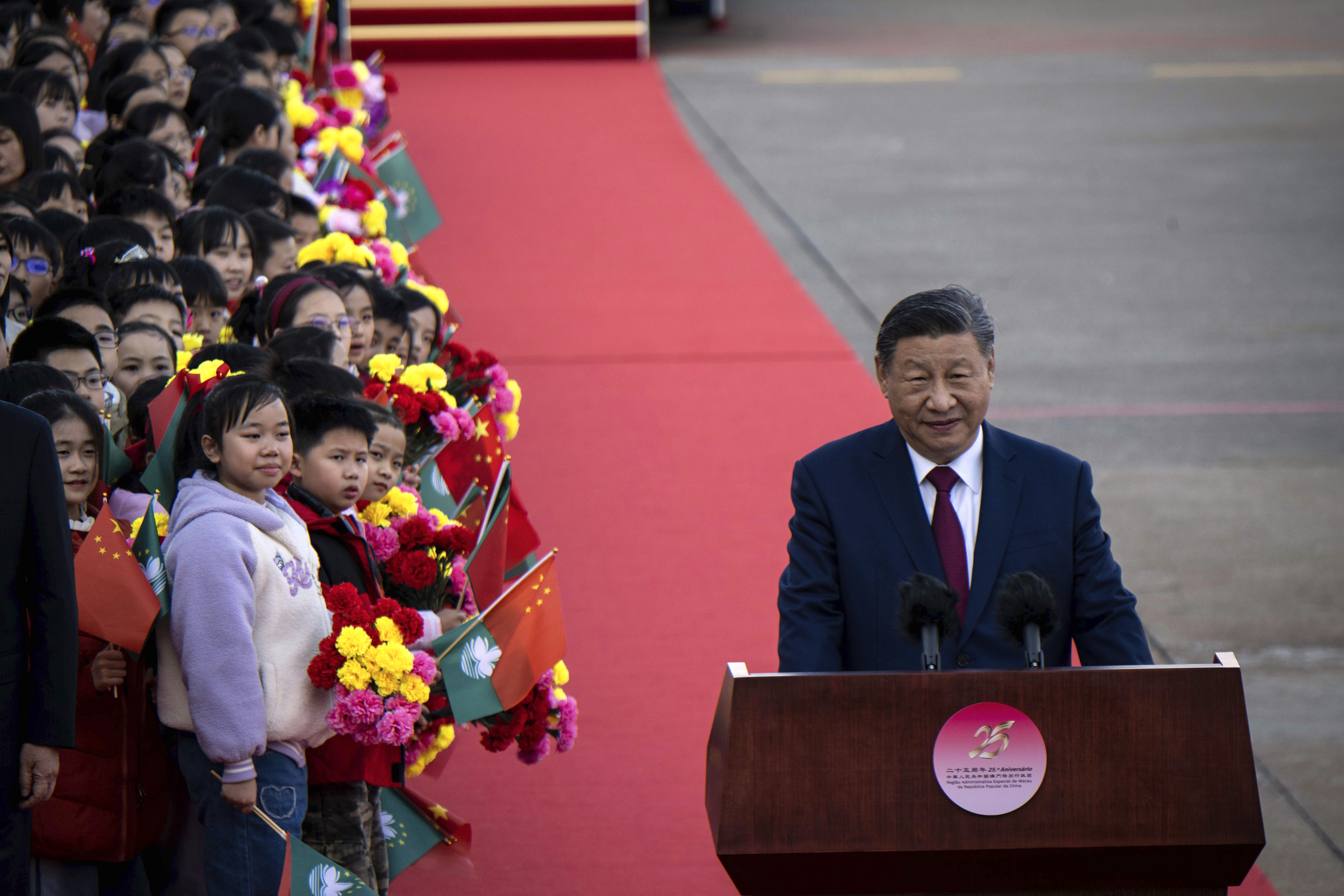 China's President Xi Jinping, right, speaks upon his arrival at the airport in Macao, China, Wednesday, Dec. 18, 2024, ahead of celebrations marking the 25th anniversary of the casino city’s return to Chinese rule. (Eduardo Leal/Pool Photo via AP)