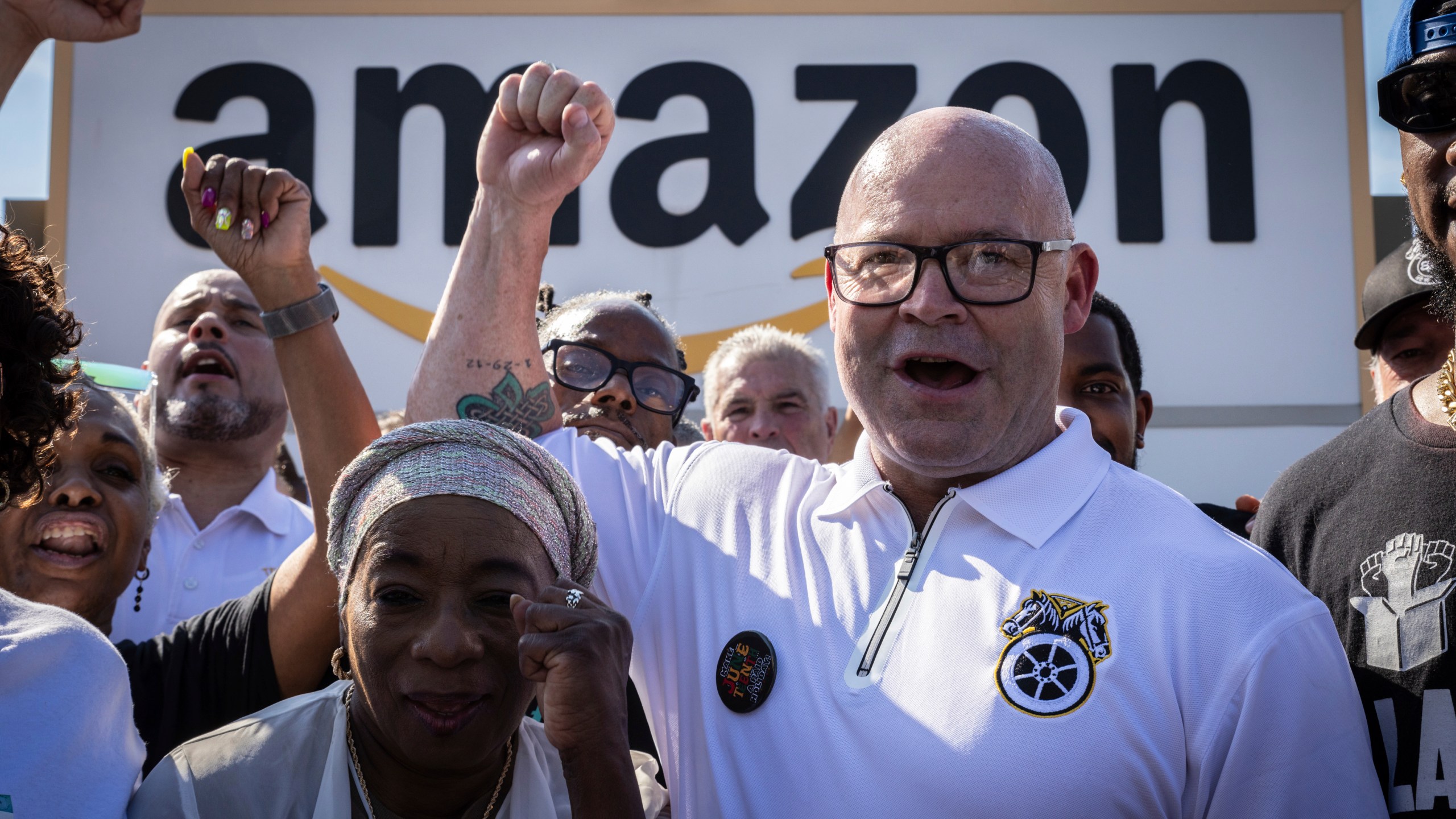 FILE - Teamsters General President Sean M. O'Brien, center, rallies with Amazon workers outside the Staten Island Amazon facility JFK8, June 19, 2024, in New York. (AP Photo/ Stefan Jeremiah, File)