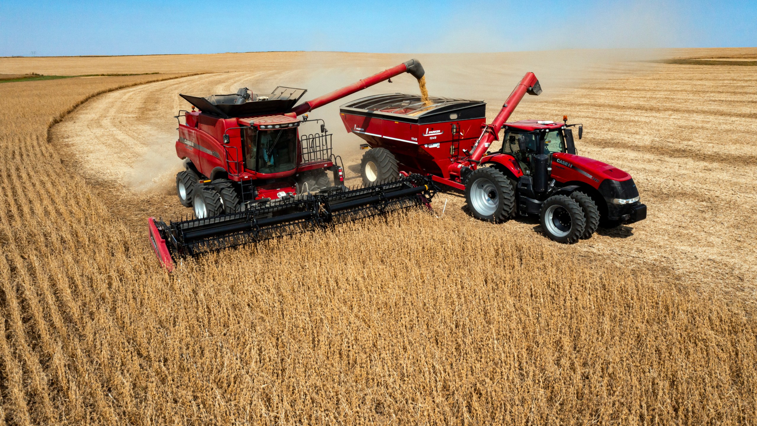 FILE - In this image taken with a drone, Jason Kwapi operates a combine, at left, during soybean harvesting on the Voss farm near Palo, Iowa, Oct. 2, 2024. (Nick Rohlman/The Gazette via AP, File)