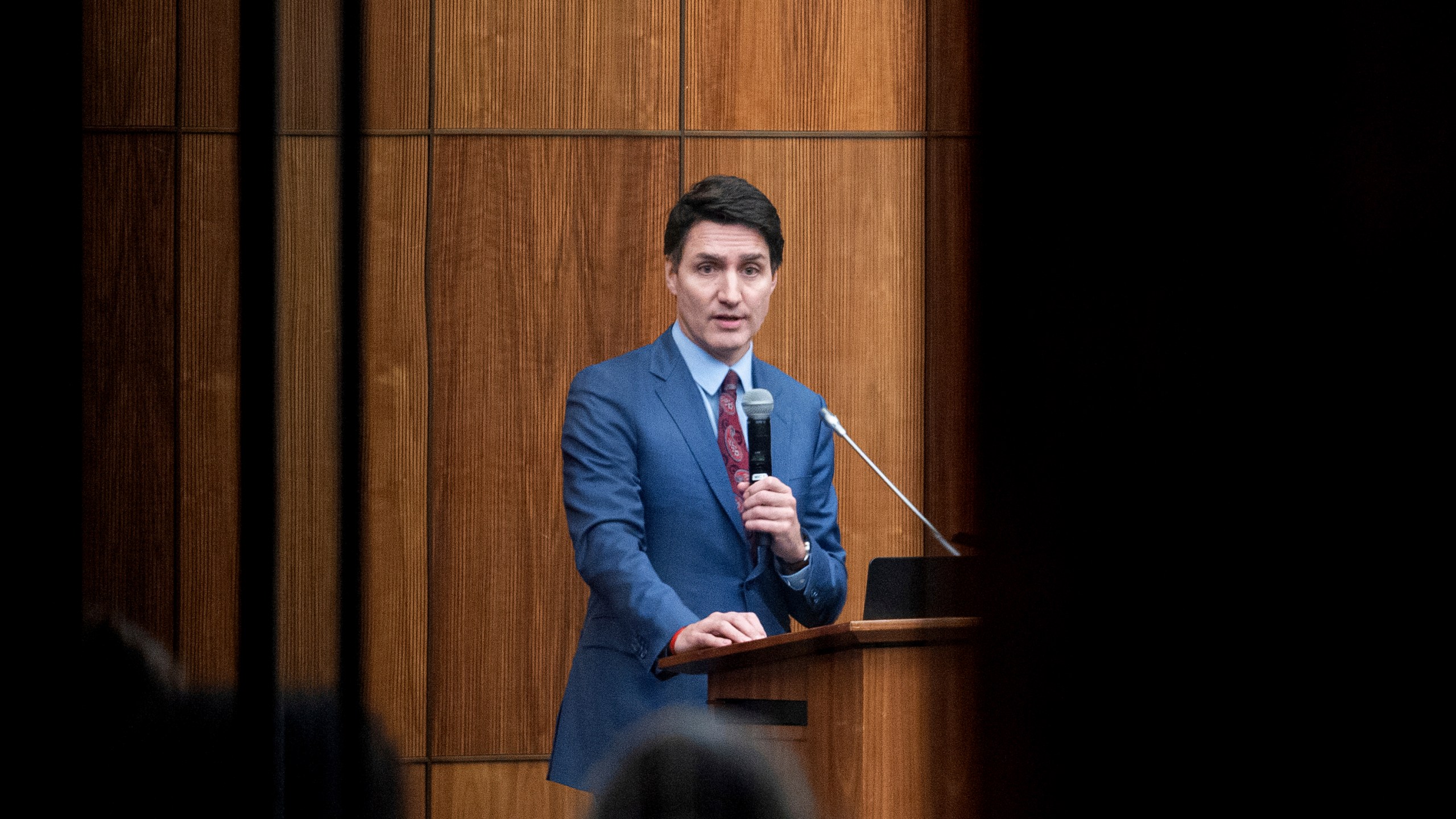 FILE - Canada's Prime Minister Justin Trudeau is pictured through glass as he speaks with members of his caucus in Ottawa, Ontario, Dec. 16, 2024. (Spencer Colby/The Canadian Press via AP, File)