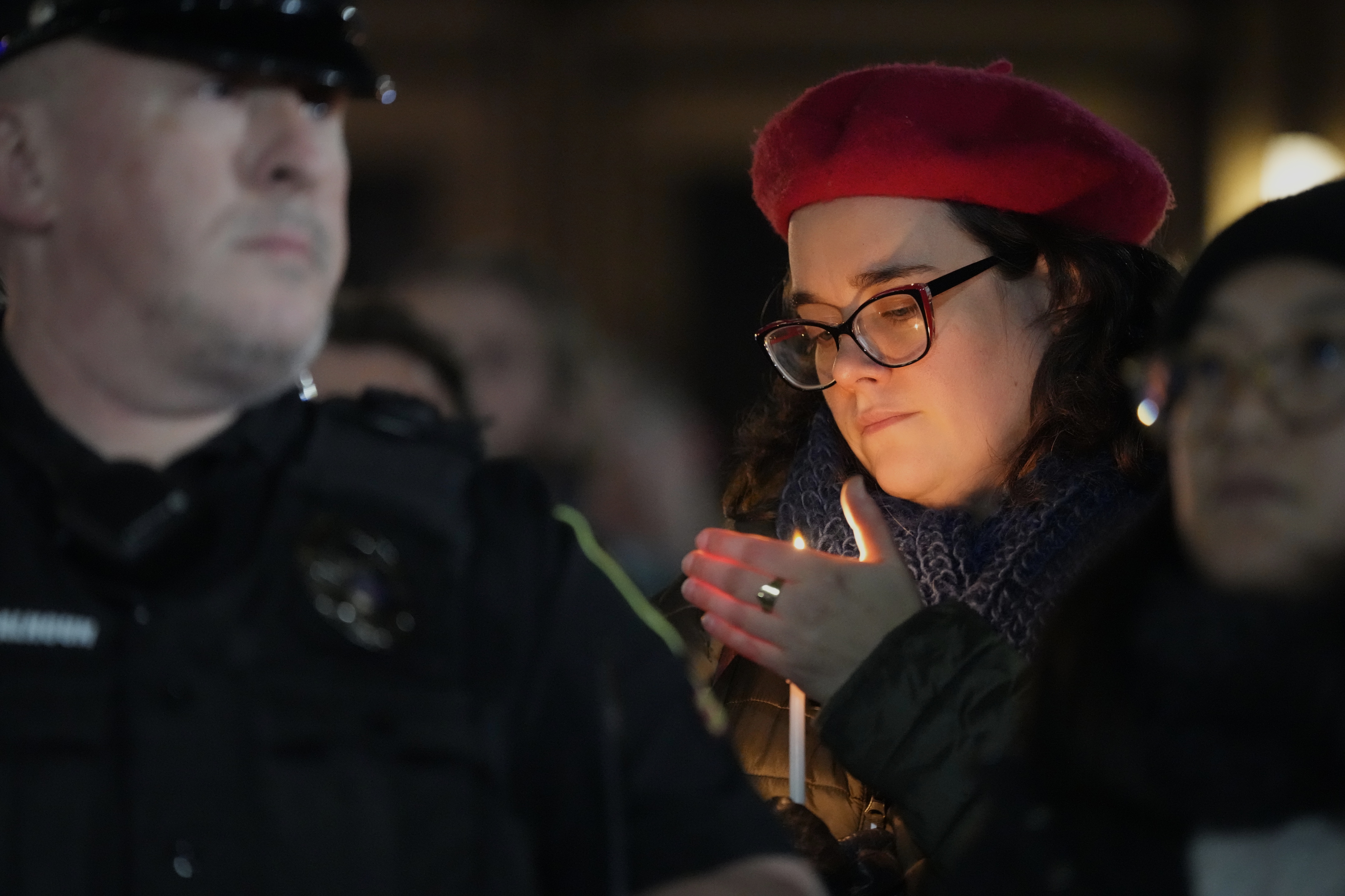 A supporter holds a candle during a candlelight vigil Tuesday, Dec. 17, 2024, outside the Wisconsin Capitol in Madison, Wis., following a shooting at the Abundant Life Christian School on Monday, Dec. 16. (AP Photo/Morry Gash)