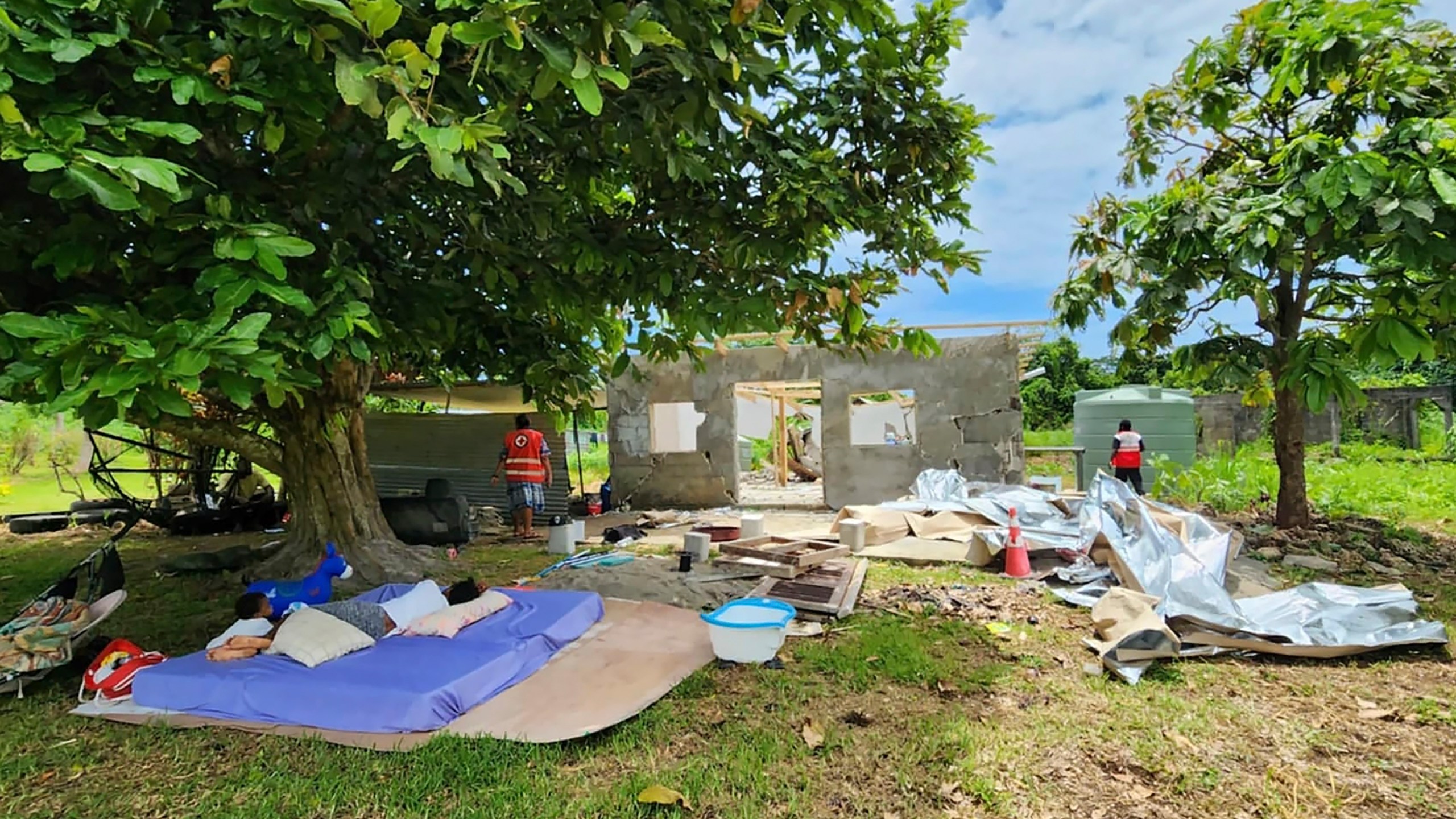 In this photo released by Vanuatu Red Cross Society, bedding lies outside a damaged house in Efate, Vanuatu, Thursday, Dec. 19, 2024, following a powerful earthquake that struck just off the coast of Vanuatu in the South Pacific Ocean. (Vanuatu Red Cross Society via AP)