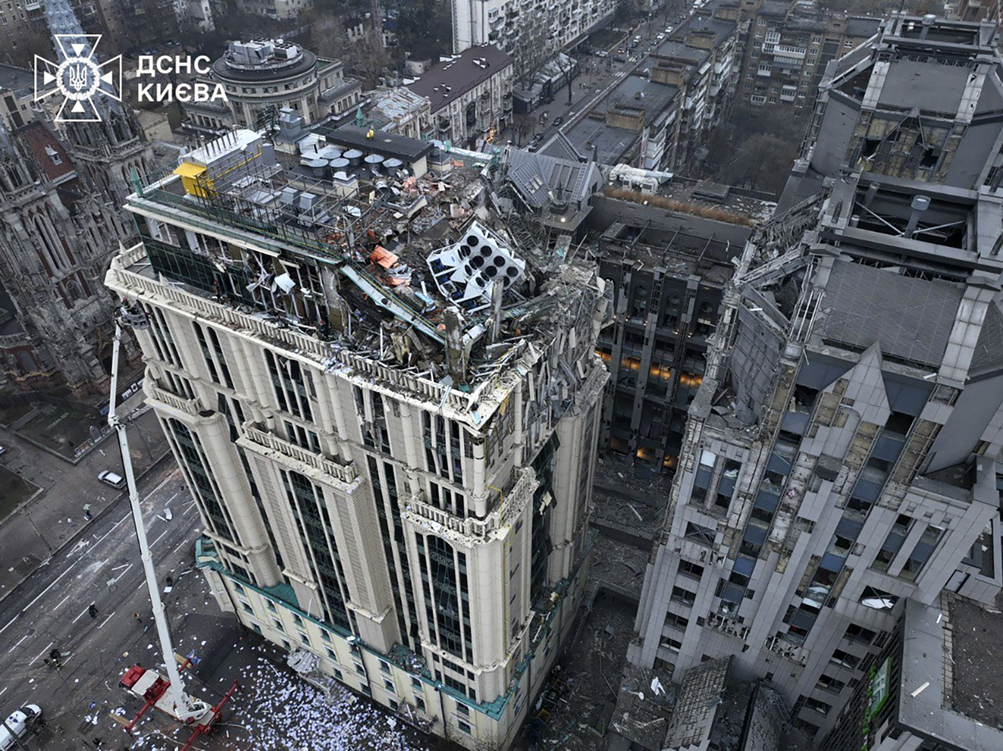 In this photo provided by the Ukrainian Emergency Service, firefighters work on the site of a damaged building after a Russian missile attack in Kyiv, Ukraine, Friday, Dec. 20, 2024. (Ukrainian Emergency Service via AP)