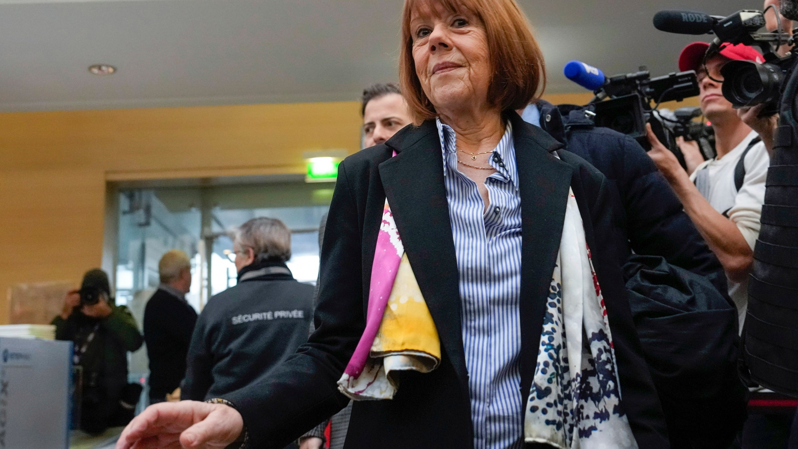 FILE - Gisele Pelicot, who was allegedly drugged by her now former husband so that he and others could assault her, arrives at the court house wearing a scarf printed with artwork of Martu woman, Mulyatingki Marney, in Avignon, southern France, on Dec. 19, 2024. (AP Photo/Lewis Joly, File)