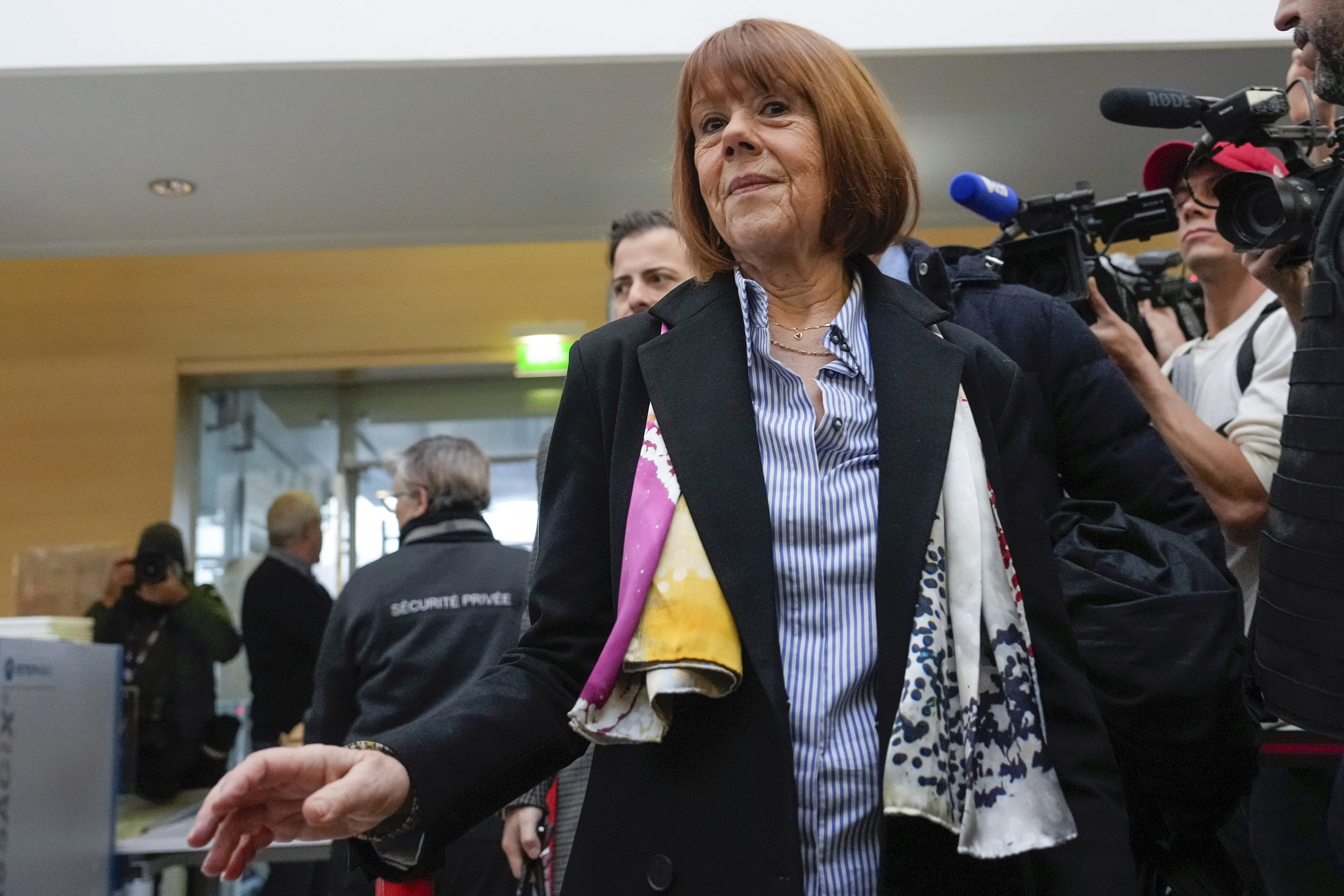 FILE - Gisele Pelicot, who was allegedly drugged by her now former husband so that he and others could assault her, arrives at the court house wearing a scarf printed with artwork of Martu woman, Mulyatingki Marney, in Avignon, southern France, on Dec. 19, 2024. (AP Photo/Lewis Joly, File)