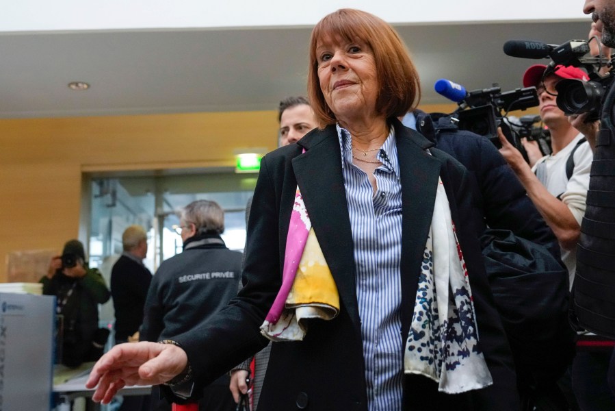 FILE - Gisele Pelicot, who was allegedly drugged by her now former husband so that he and others could assault her, arrives at the court house wearing a scarf printed with artwork of Martu woman, Mulyatingki Marney, in Avignon, southern France, on Dec. 19, 2024. (AP Photo/Lewis Joly, File)