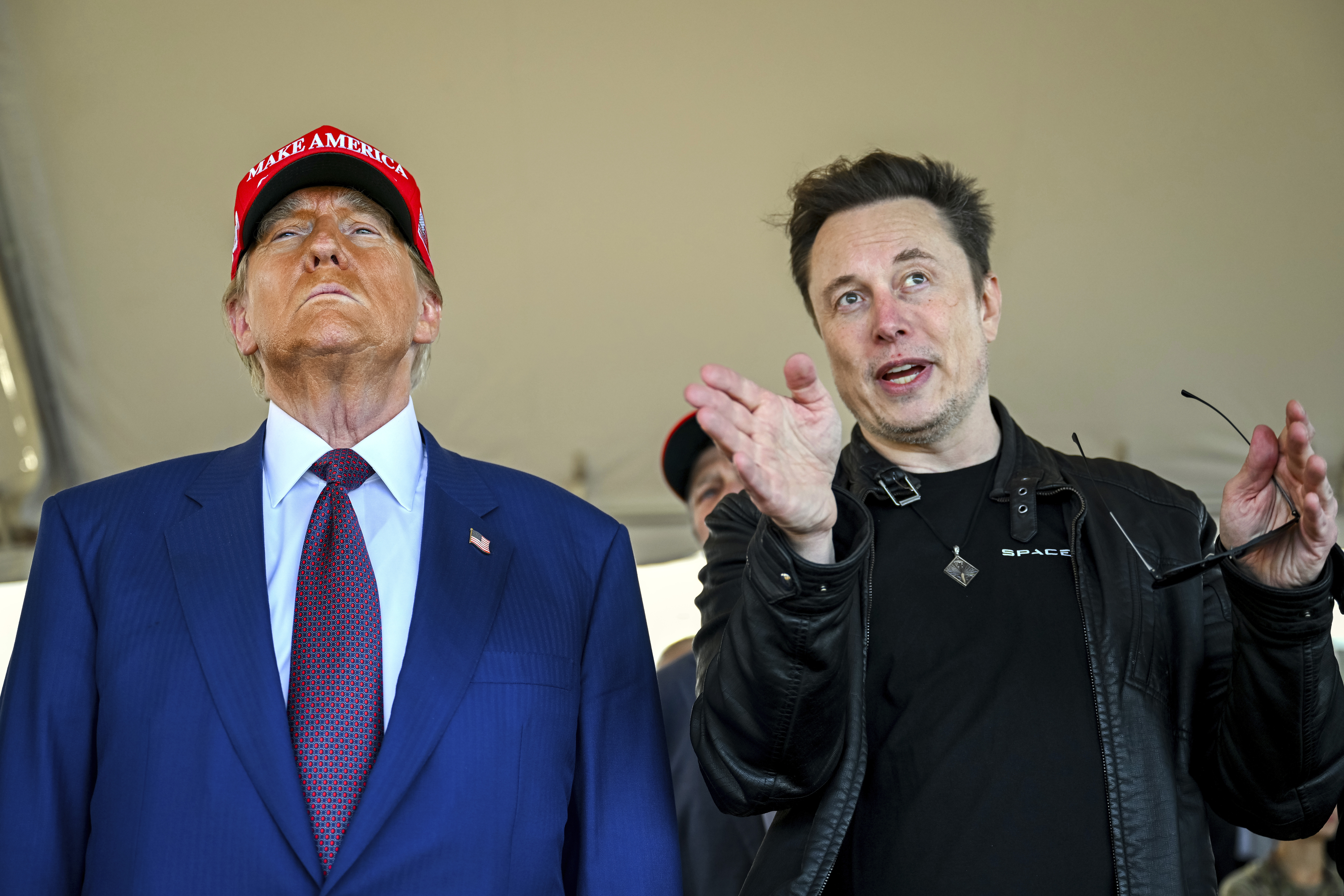 FILE - President-elect Donald Trump listens to Elon Musk as he arrives to watch SpaceX's mega rocket Starship lift off for a test flight from Starbase in Boca Chica, Texas, Nov. 19, 2024. (Brandon Bell/Pool via AP, File)