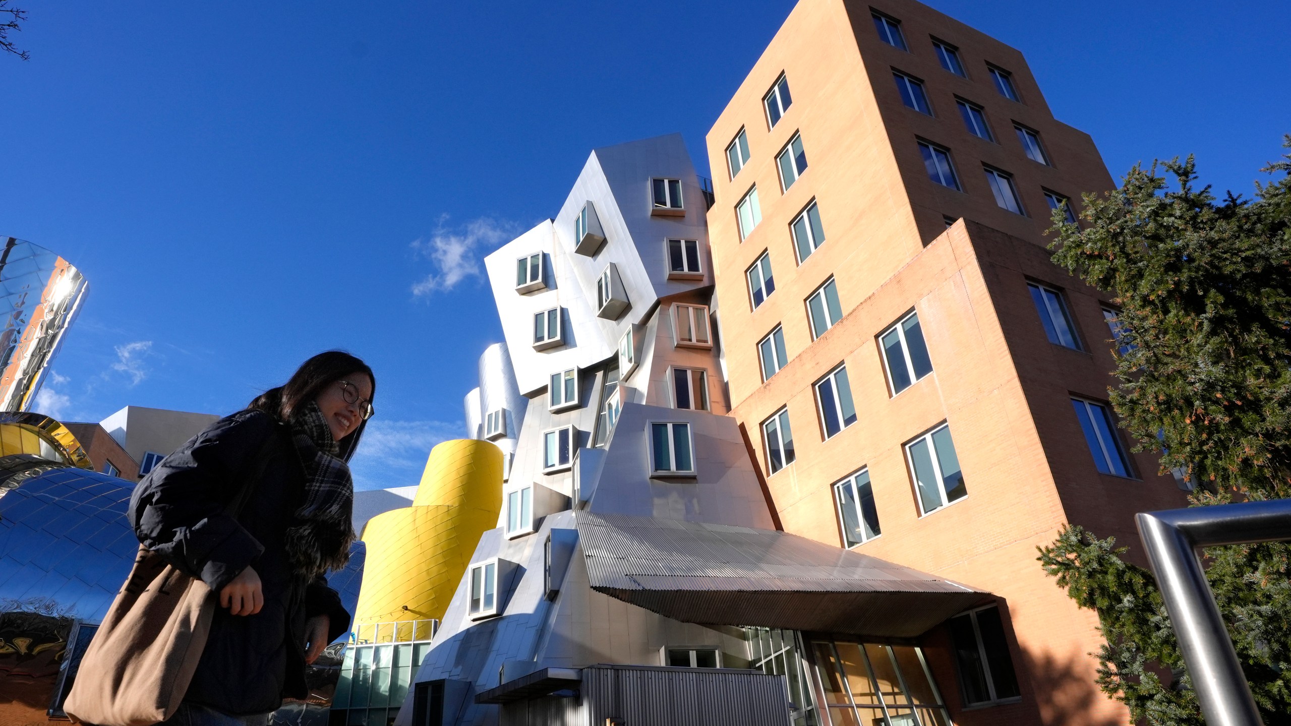 A person walks near buildings, Tuesday, Dec. 17, 2024, on the campus of Massachusetts Institute of Technology in Cambridge, Mass. (AP Photo/Steven Senne)