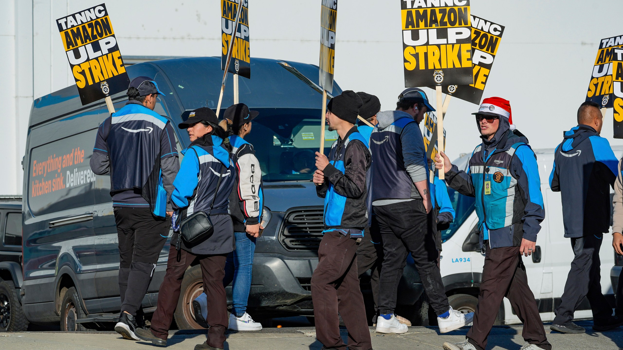 Amazon workers strike outside the gates of an Amazon Fulfillment Center as Teamsters seek labor contract nationwide Thursday, Dec. 19, 2024, in City of Industry, Calif. (AP Photo/Damian Dovarganes)