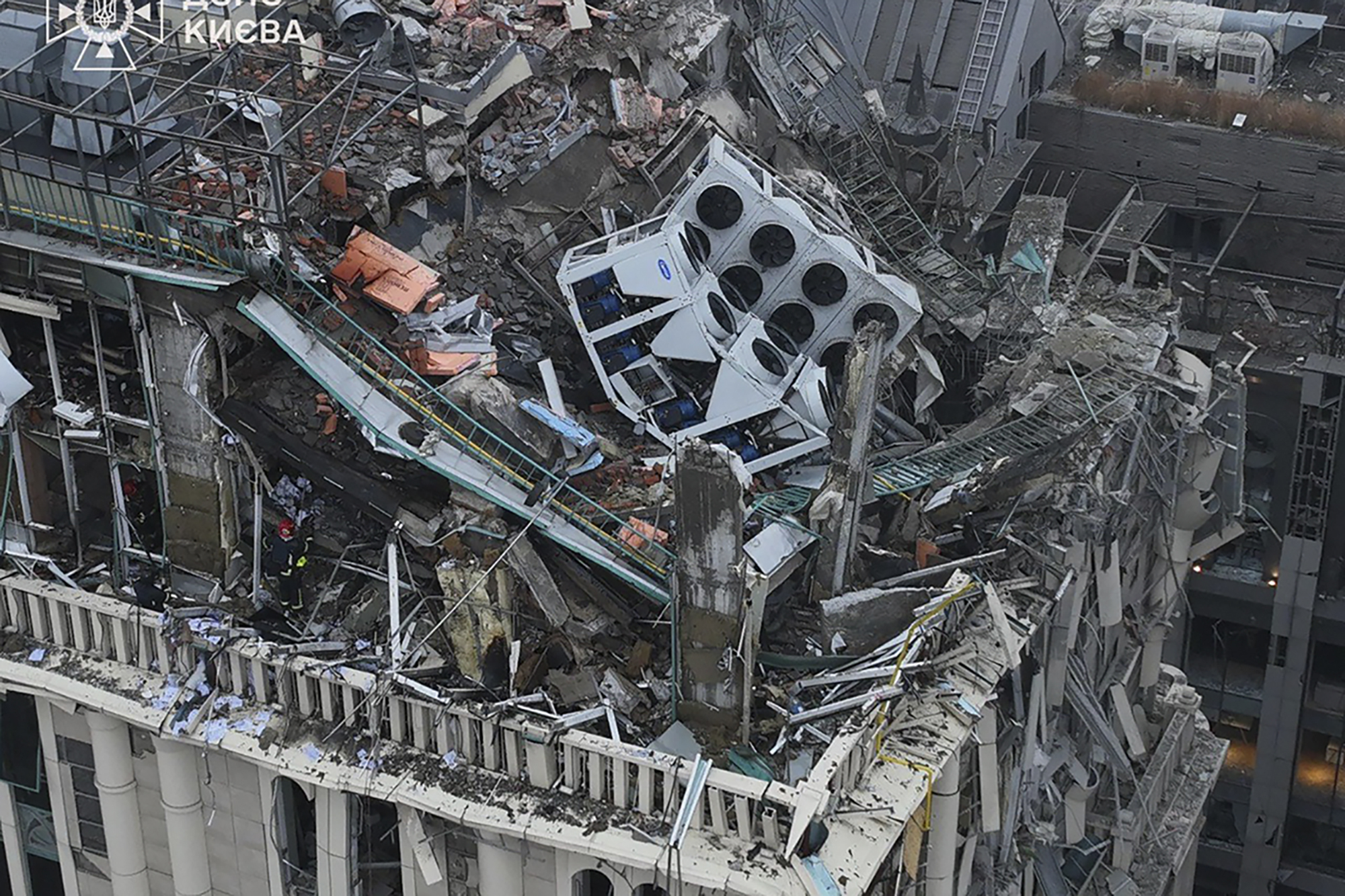 In this photo provided by the Ukrainian Emergency Service, firefighters work on the site of a damaged building after a Russian missile attack in Kyiv, Ukraine, Friday, Dec. 20, 2024. (Ukrainian Emergency Service via AP)