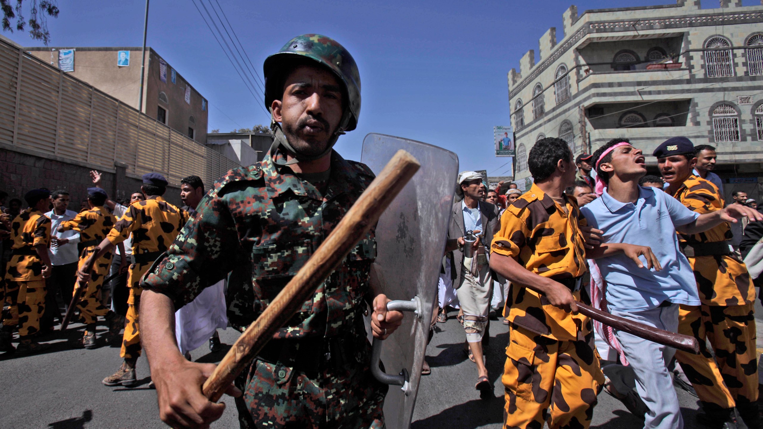 FILE - Yemeni riot police charge towards anti-government protesters during a demonstration demanding the resignation of President Ali Abdullah Saleh in Sanaa, Yemen, on Feb. 18, 2011. (AP Photo/Muhammed Muheisen, File)