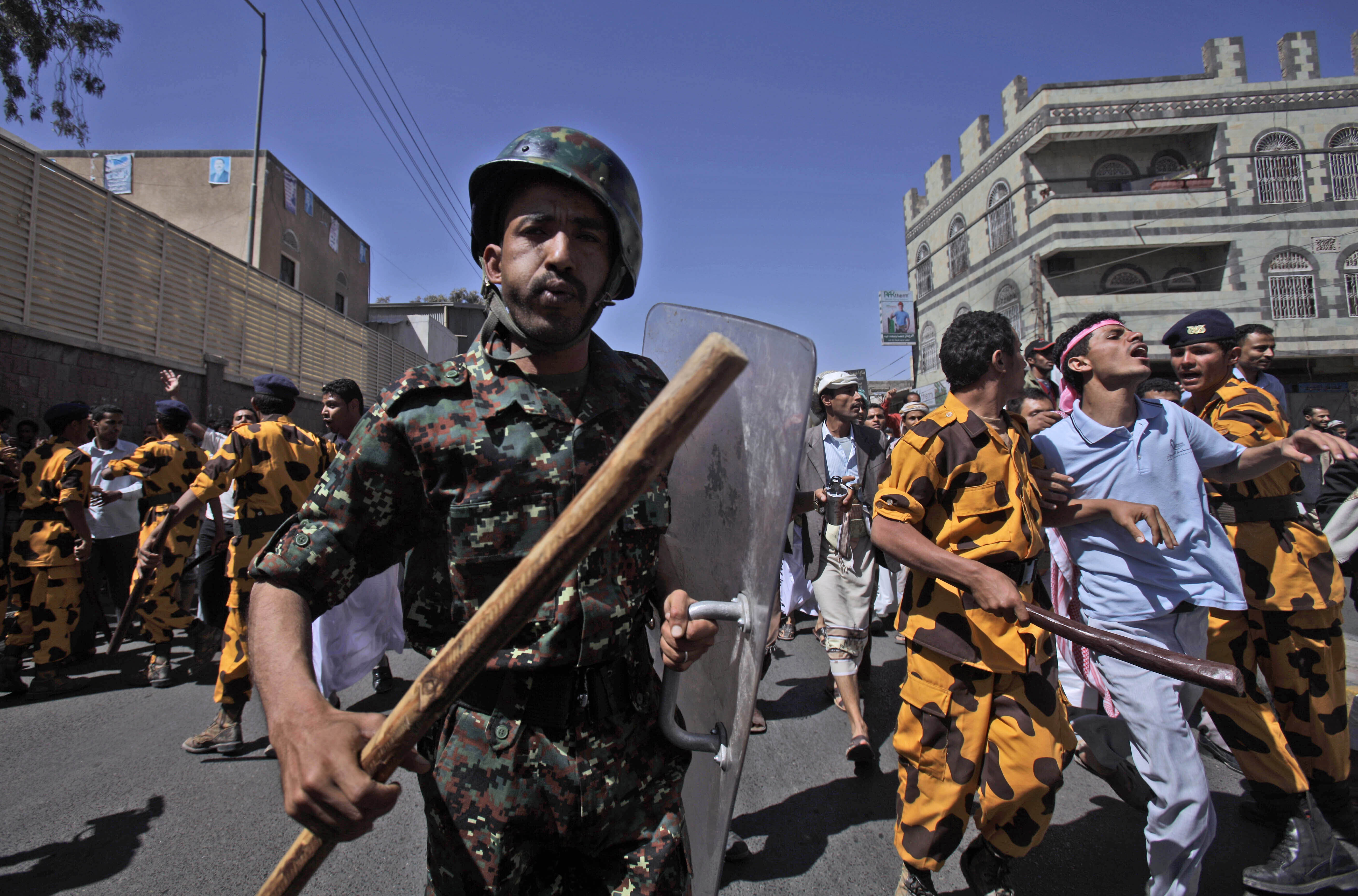 FILE - Yemeni riot police charge towards anti-government protesters during a demonstration demanding the resignation of President Ali Abdullah Saleh in Sanaa, Yemen, on Feb. 18, 2011. (AP Photo/Muhammed Muheisen, File)