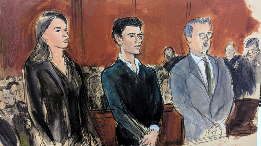 Luigi Mangione, center, stands flanked by his attorneys Karen Agnifilo, left and Marc Agnifilo, right, during his initial court appearance in Manhattan federal court, Thursday, Dec. 19, 2024, in New York. (Elizabeth Williams via AP)