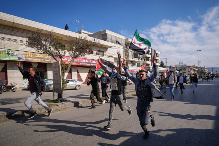 FILE - Syrians celebrate the fall of Bashar Assad's government in the town of Bar Elias, Lebanon, near the border with Syria, Sunday, Dec. 8, 2024. (AP Photo/Hassan Ammar, File)