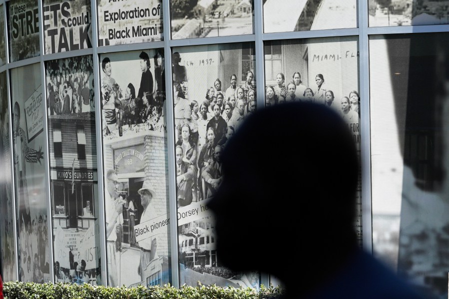 Dr. Marvin Dunn is silhouetted in front of a mural at the Lyric Theater Sunday, Feb. 25, 2024, in Miami. (AP Photo/Marta Lavandier, file)