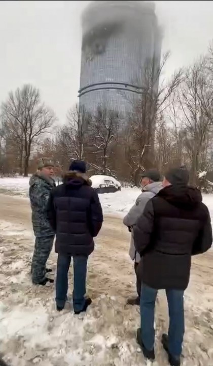 In this photo released Saturday, Dec. 21, 2024, by the official Telegram channel of the Kazan City Hall, local officials look at a damage site at the residential complex called "Lazurnye Nebesa," or Azure Skies, in Kazan, Russia, following Ukrainian drone attacks. (Official Telegram channel of the Kazan City Hall via AP)